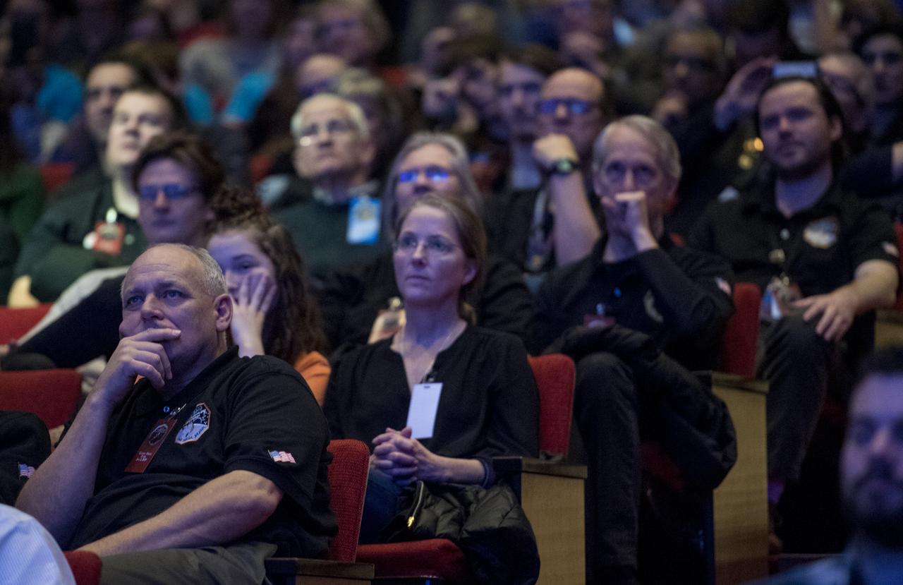 New Horizons team members and guests watch a live feed of the Mission Operations Center (MOC) as the team waits to receive confirmation from the spacecraft that it has completed the flyby of Ultima Thule, Tuesday, Jan. 1, 2019 at Johns Hopkins University Applied Physics Laboratory (APL) in Laurel, Maryland. Photo Credit: (NASA/Joel Kowsky)