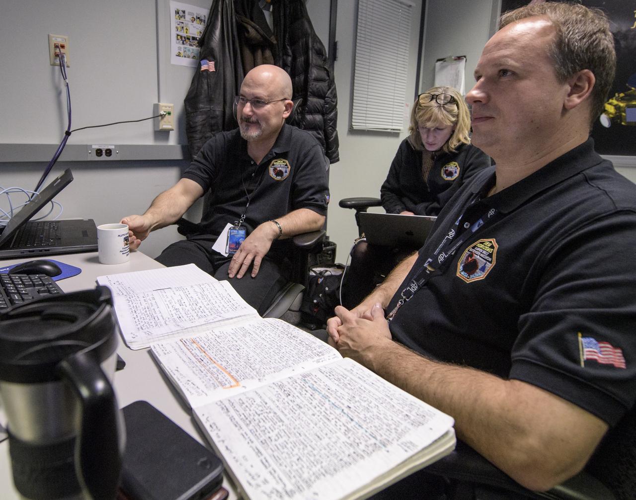 New Horizons Mission Systems Engineer Chris Hersman, left, New Horizons Project Manager Helene Winters, and New Horizons Deputy Mission Systems Engineer Gabe Rogers, right, all of the Johns Hopkins Applied Physics Laboratory, wait for a signal from the spacecraft that it is healthy and collected data during the flyby of Ultima Thule, Tuesday, Jan. 1, 2019 at the Mission Operations Center of the Johns Hopkins University Applied Physics Laboratory (APL) in Laurel, Maryland. Photo Credit: (NASA/Bill Ingalls)