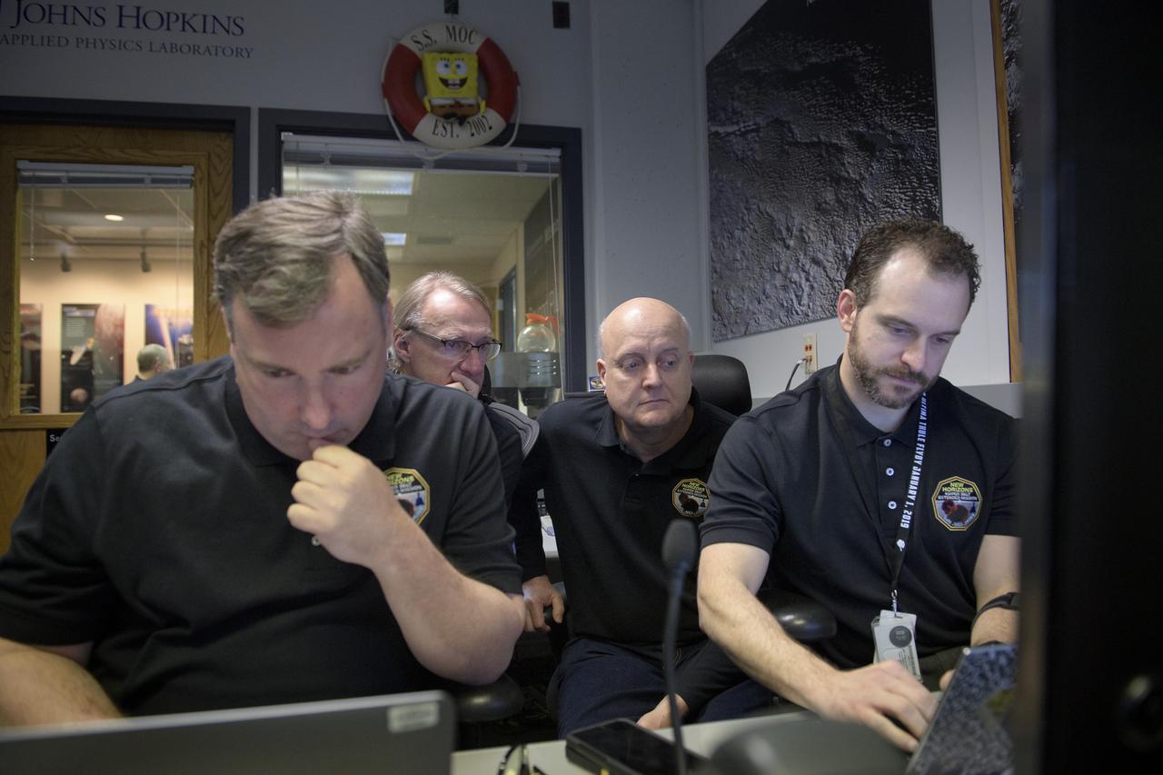 New Horizons mission managers: Chris DeBoy, left, Mark Kochte, Rick Shelton, and Michael Vincent, right, wait for a signal from the spacecraft that it is healthy and collected data during the flyby of Ultima Thule, Tuesday, Jan. 1, 2019 in the Mission Operations Center at Johns Hopkins University Applied Physics Laboratory (APL) in Laurel, Maryland. Photo Credit: (NASA/Bill Ingalls)