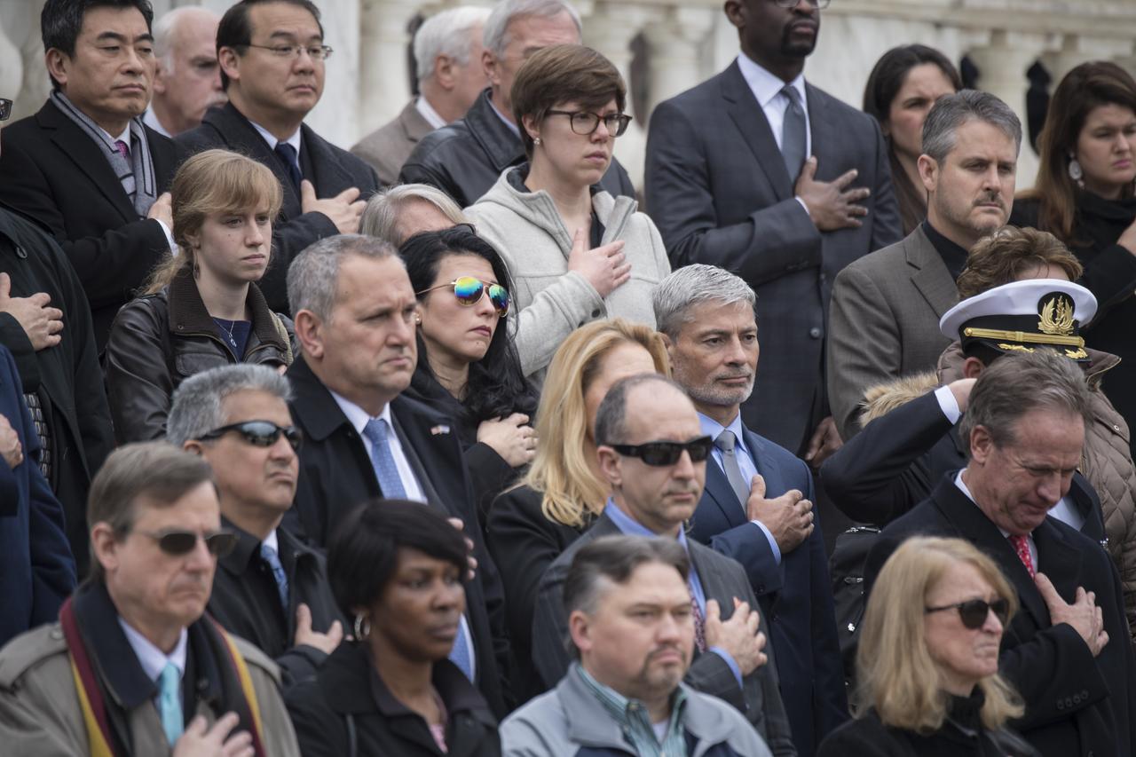 NASA personnel watch as "Taps" is played by The Old Guard after a wreath was laid at the Tomb of the Unknowns by NASA Administrator Jim Bridenstine as part of NASA's Day of Remembrance, Thursday, Feb. 7, 2019, at Arlington National Cemetery in Arlington, Va. The wreaths were laid in memory of those men and women who lost their lives in the quest for space exploration.  Photo Credit: (NASA/Aubrey Gemignani)