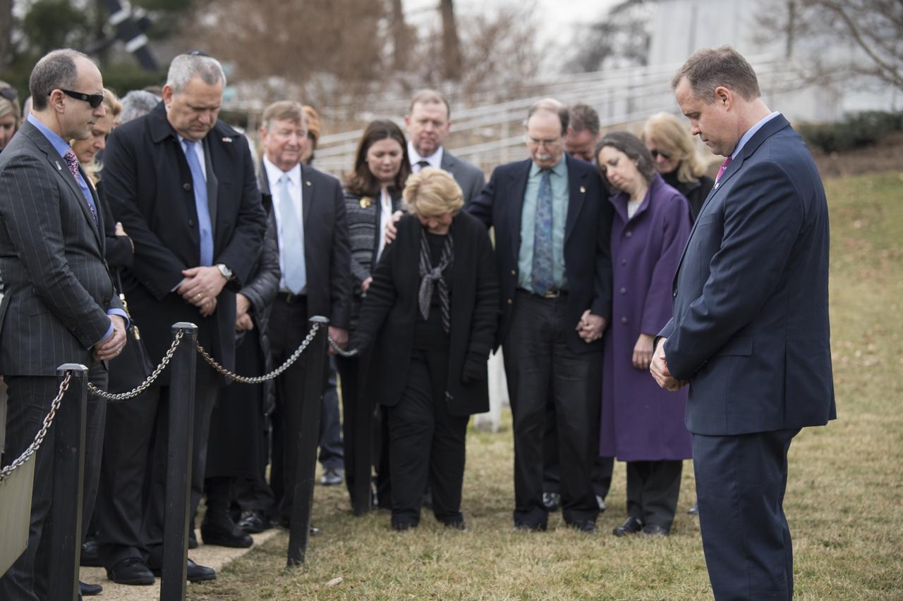 NASA Administrator Jim Bridenstine, NASA employees, and members of the public bow their heads at the Space Shuttle Challenger and Columbia memorials during a wreath laying ceremony as part of NASA's Day of Remembrance, Thursday, February 7, 2019, at Arlington National Cemetery in Arlington, Va.  The wreaths were laid in memory of those men and women who lost their lives in the quest for space exploration.  Photo Credit: (NASA/Aubrey Gemignani)
