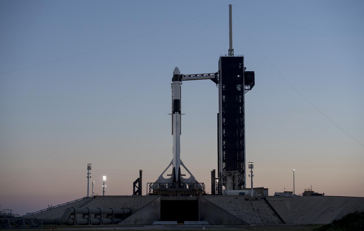 A SpaceX Falcon 9 rocket with the company's Crew Dragon spacecraft onboard is seen after being into a vertical position on the launch pad at Launch Complex 39A as preparations continue for the Demo-1 mission, Feb. 28, 2019 at the Kennedy Space Center in Florida. The Demo-1 mission will be the first launch of a commercially built and operated American spacecraft and space system designed for humans as part of NASA's Commercial Crew Program. The mission, currently targeted for a 2:49am launch on March 2, will serve as an end-to-end test of the system's capabilities. Photo Credit: (NASA/Joel Kowsky)