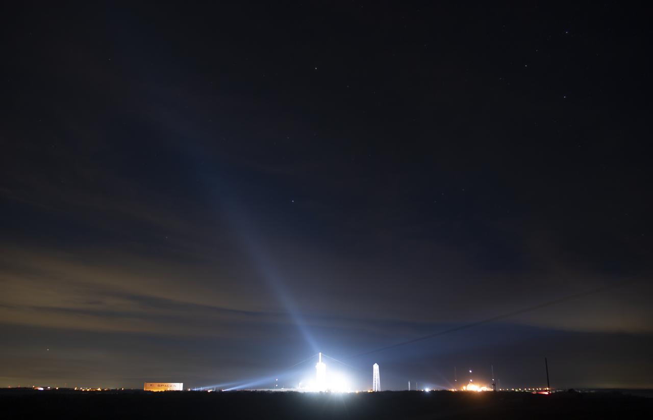 A SpaceX Falcon 9 rocket with the company's Crew Dragon spacecraft onboard is seen illuminated by spotlights on the launch pad at Launch Complex 39A as preparations continue for the Demo-1 mission, Thursday, Feb. 28, 2019 at the Kennedy Space Center in Florida. The Demo-1 mission will be the first launch of a commercially built and operated American spacecraft and space system designed for humans as part of NASA's Commercial Crew Program. The mission, currently targeted for a 2:49am launch on March 2, will serve as an end-to-end test of the system's capabilities. Photo Credit: (NASA/Joel Kowsky)