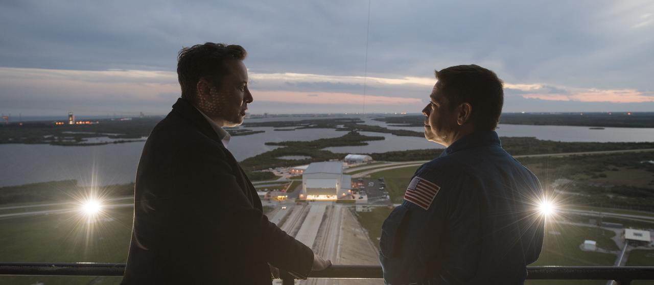 SpaceX CEO and Chief Designer Elon Musk, left, speaks with NASA astronaut Bob Behnken on the fixed service structure of Launch Complex 39A during a tour before the early Saturday morning launch of the Demo-1 mission, Friday, March 1, 2019 at the Kennedy Space Center in Florida. The Demo-1 mission launched at 2:49am ET on Saturday, March 2 and was the first launch of a commercially built and operated American spacecraft and space system designed for humans as part of NASA's Commercial Crew Program. The mission will serve as an end-to-end test of the system's capabilities. Behnken and fellow NASA astronaut Doug Hurley are assigned to fly onboard Crew Dragon for the Demo-2 mission. Photo Credit: (NASA/Joel Kowsky)
