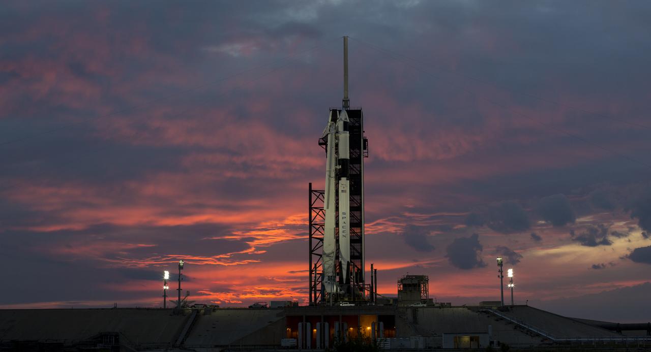 A SpaceX Falcon 9 rocket with the company's Crew Dragon spacecraft onboard is seen at sunset on the launch pad at Launch Complex 39A as preparations continue for the Demo-1 mission, Friday, March 1, 2019 at the Kennedy Space Center in Florida. The Demo-1 mission launched at 2:49am ET on Saturday, March 2 and was the first launch of a commercially built and operated American spacecraft and space system designed for humans as part of NASA's Commercial Crew Program. The mission will serve as an end-to-end test of the system's capabilities. Photo Credit: (NASA/Joel Kowsky)