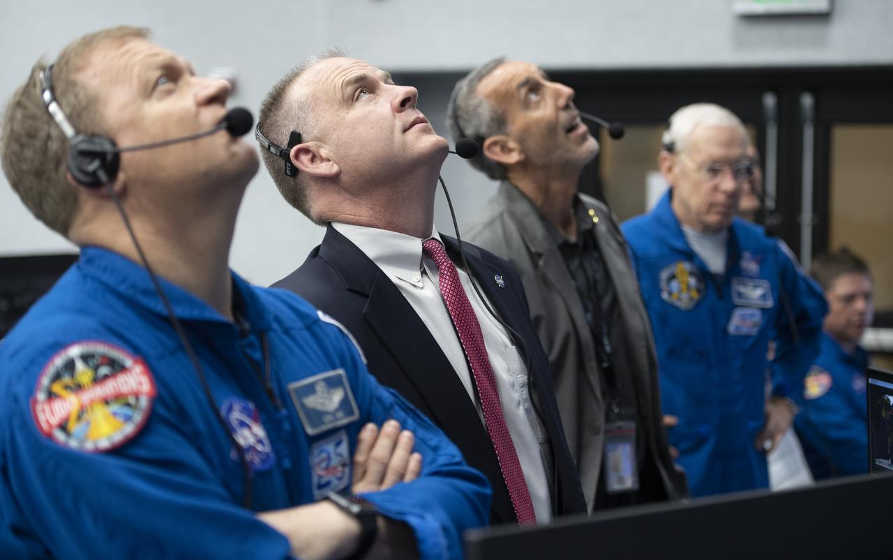 NASA astronaut Eric Boe, assistant to the chief of the astronaut office for commercial crew, left, and Norm Knight, deputy director of flight operations at NASA's Johnson Space Center watch the launch of a SpaceX Falcon 9 rocket carrying the company's Crew Dragon spacecraft on the Demo-1 mission from firing room four of the Launch Control Center, Saturday, March 2, 2019 at the Kennedy Space Center in Florida. The Demo-1 mission is the first launch of a commercially built and operated American spacecraft and space system designed for humans as part of NASA's Commercial Crew Program. The mission will serve as an end-to-end test of the system's capabilities. Photo Credit: (NASA/Joel Kowsky)
