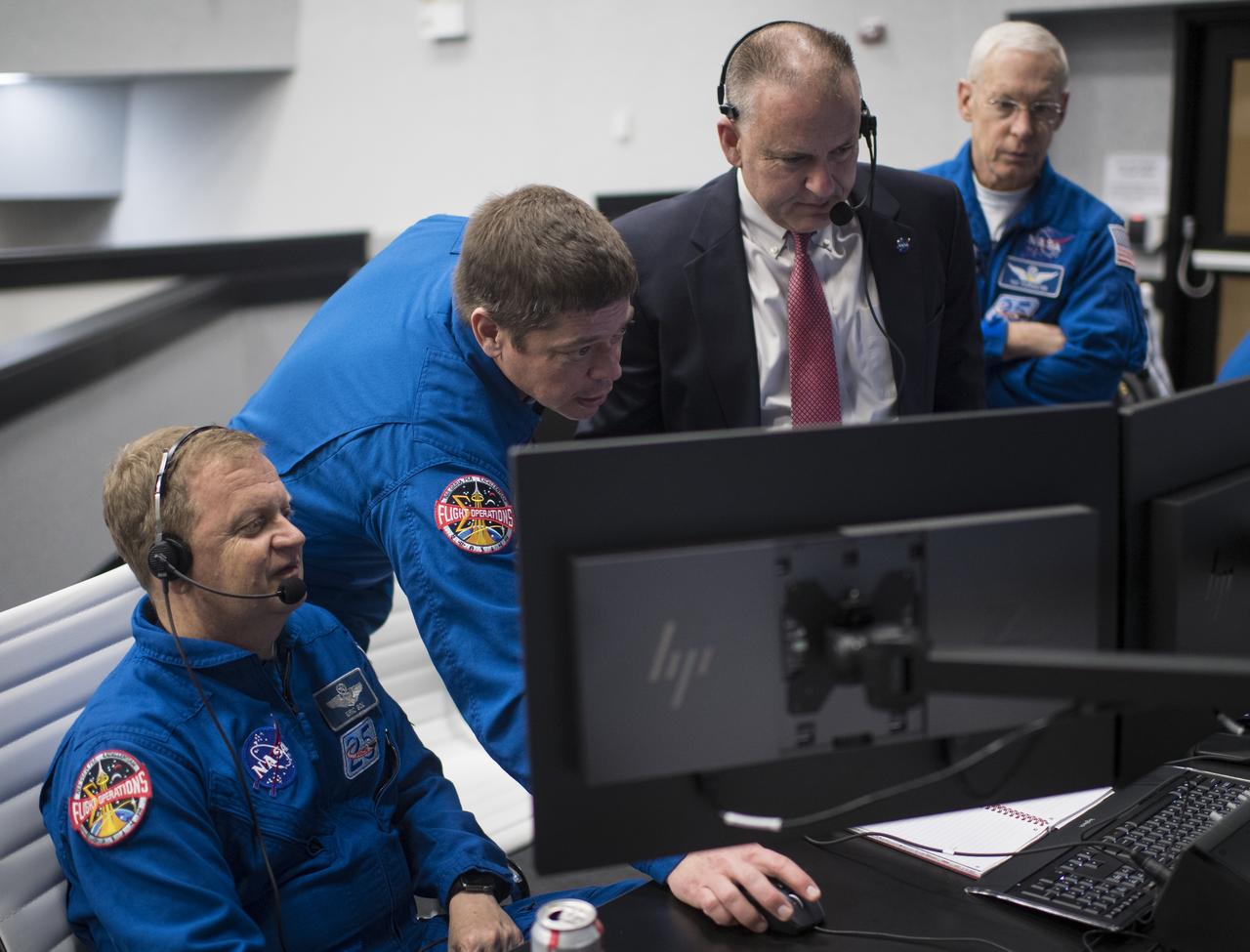 NASA astronaut Eric Boe, assistant to the chief of the astronaut office for commercial crew, left, NASA astronaut Bob Behnken, Norm Knight, deputy director of flight operations at NASA's Johnson Space Center and chief of the astronaut office Pat Forrester monitor the countdown of the launch of a SpaceX Falcon 9 rocket carrying the company's Crew Dragon spacecraft on the Demo-1 mission from firing room four of the Launch Control Center, Saturday, March 2, 2019 at the Kennedy Space Center in Florida. The Demo-1 mission will be the first launch of a commercially built and operated American spacecraft and space system designed for humans as part of NASA's Commercial Crew Program. The mission will serve as an end-to-end test of the system's capabilities. Photo Credit: (NASA/Joel Kowsky)