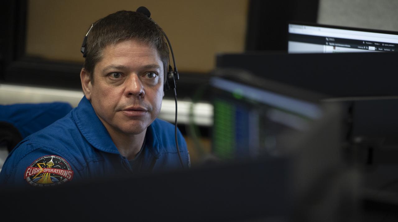 NASA astronaut Bob Behnken monitors the countdown of the launch of a SpaceX Falcon 9 rocket carrying the company's Crew Dragon spacecraft on the Demo-1 mission from firing room four of the Launch Control Center, Saturday, March 2, 2019 at the Kennedy Space Center in Florida. Behnken, along with NASA astronaut Doug Hurley are assigned to fly on the crewed Demo-2 mission. The Demo-1 mission will be the first launch of a commercially built and operated American spacecraft and space system designed for humans as part of NASA's Commercial Crew Program. The mission will serve as an end-to-end test of the system's capabilities. Photo Credit: (NASA/Joel Kowsky)