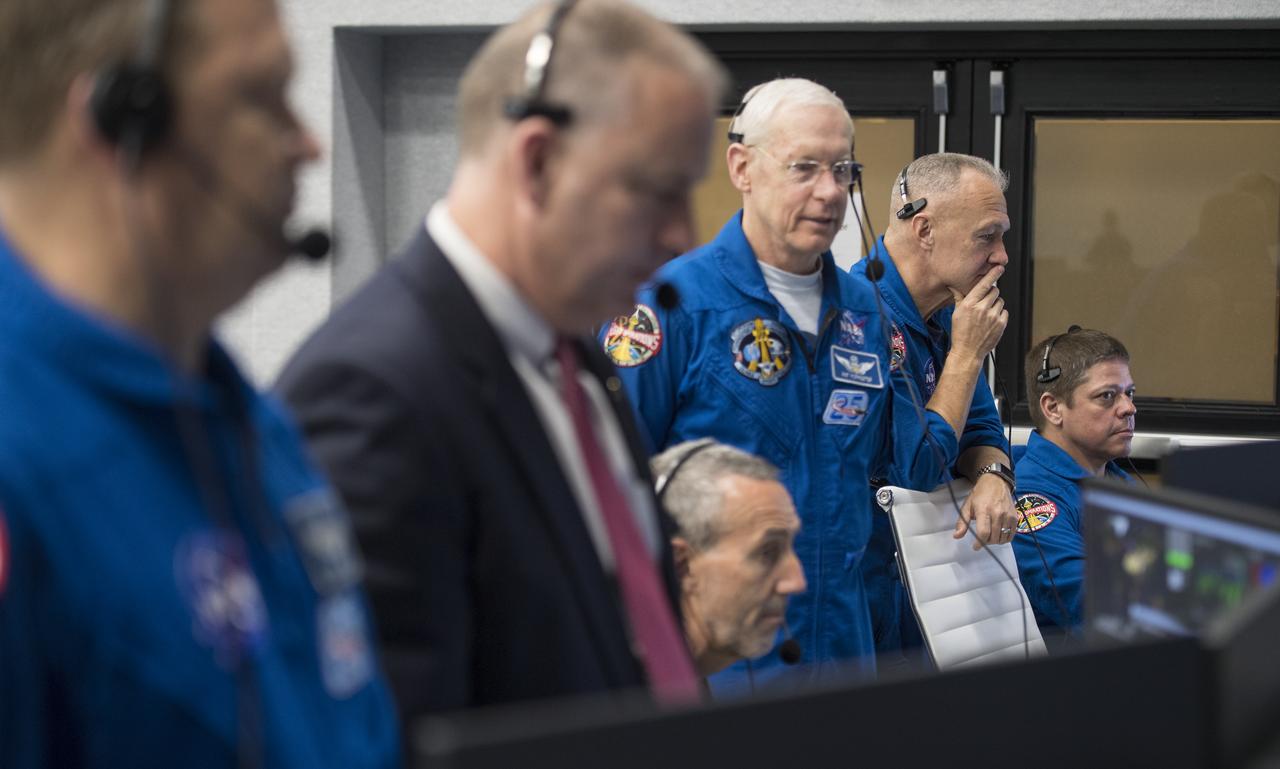 NASA's chief of the astronaut office Pat Forrester, third from right and NASA astronauts Doug Hurley, second from right, and Bob Behnken, right, who are assigned to fly on the crewed Demo-2 mission, monitor the countdown of the launch of a SpaceX Falcon 9 rocket carrying the company's Crew Dragon spacecraft on the Demo-1 mission from firing room four of the Launch Control Center, Saturday, March 2, 2019 at the Kennedy Space Center in Florida. The Demo-1 mission will be the first launch of a commercially built and operated American spacecraft and space system designed for humans as part of NASA's Commercial Crew Program. The mission will serve as an end-to-end test of the system's capabilities. Photo Credit: (NASA/Joel Kowsky)