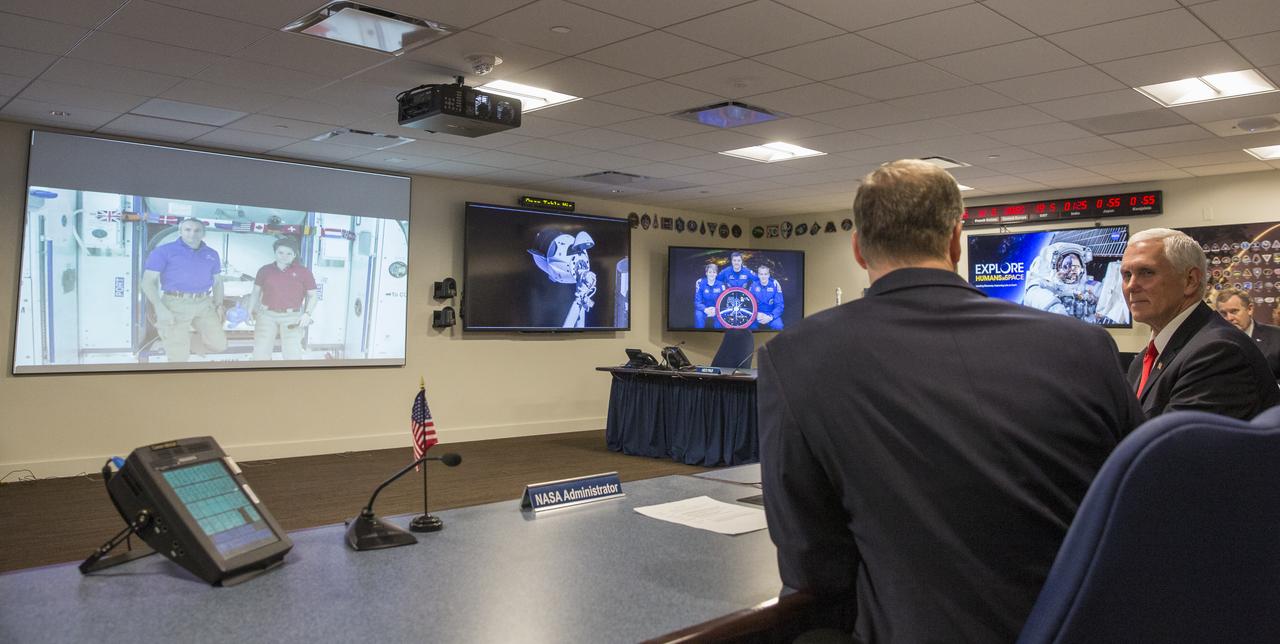 Vice President Mike Pence, right, and NASA Administrator Jim Bridenstine, left, speak with Expedition 58 flight engineer Anne McClain of NASA, and flight engineer David Saint-Jacques of the Canadian Space Agency (CSA) who are onboard the International Space Station, Wednesday, March 6, 2019 from the Space Operations Center at NASA Headquarters in Washington. Vice President Pence and Administrator Bridenstine spoke with the astronauts about the arrival of SpaceX's Crew Dragon spacecraft at the International Space Station. Photo Credit: (NASA/Joel Kowsky)