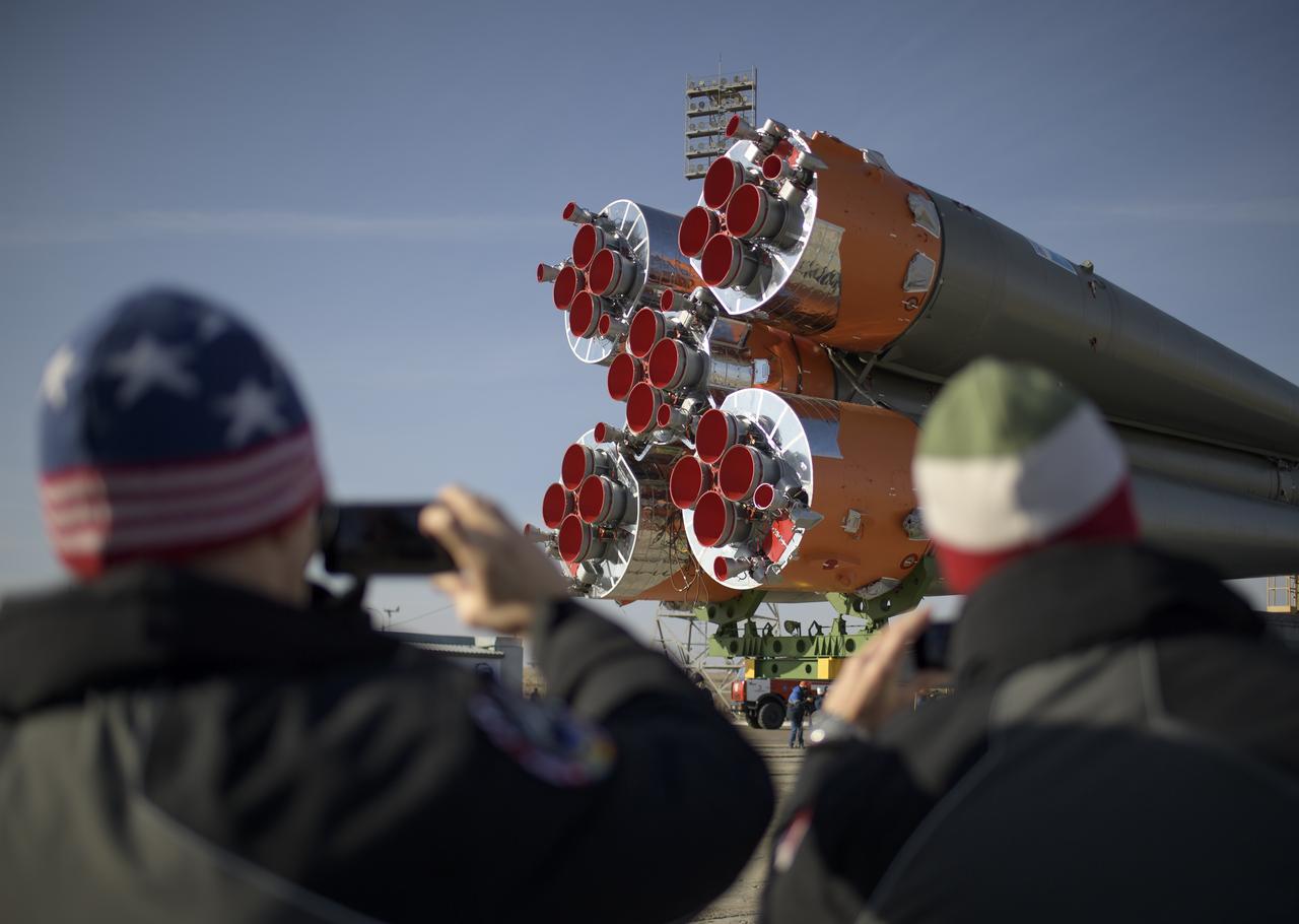 Expedition 59 backup crewmembers Drew Morgan of NASA, left, and Luca Parmitano of the European Space Agency watch as the Soyuz rocket is transported by train to the launch pad, Tuesday, March 12, 2019 at the Baikonur Cosmodrome in Kazakhstan. Expedition 59 crewmembers Nick Hague and Christina Koch of NASA, along with Alexey Ovchinin of Roscosmos, will launch March 14, U.S. time, on the Soyuz MS-12 spacecraft from the Baikonur Cosmodrome for a six-and-a-half month mission on the International Space Station. Photo Credit: (NASA/Bill Ingalls)