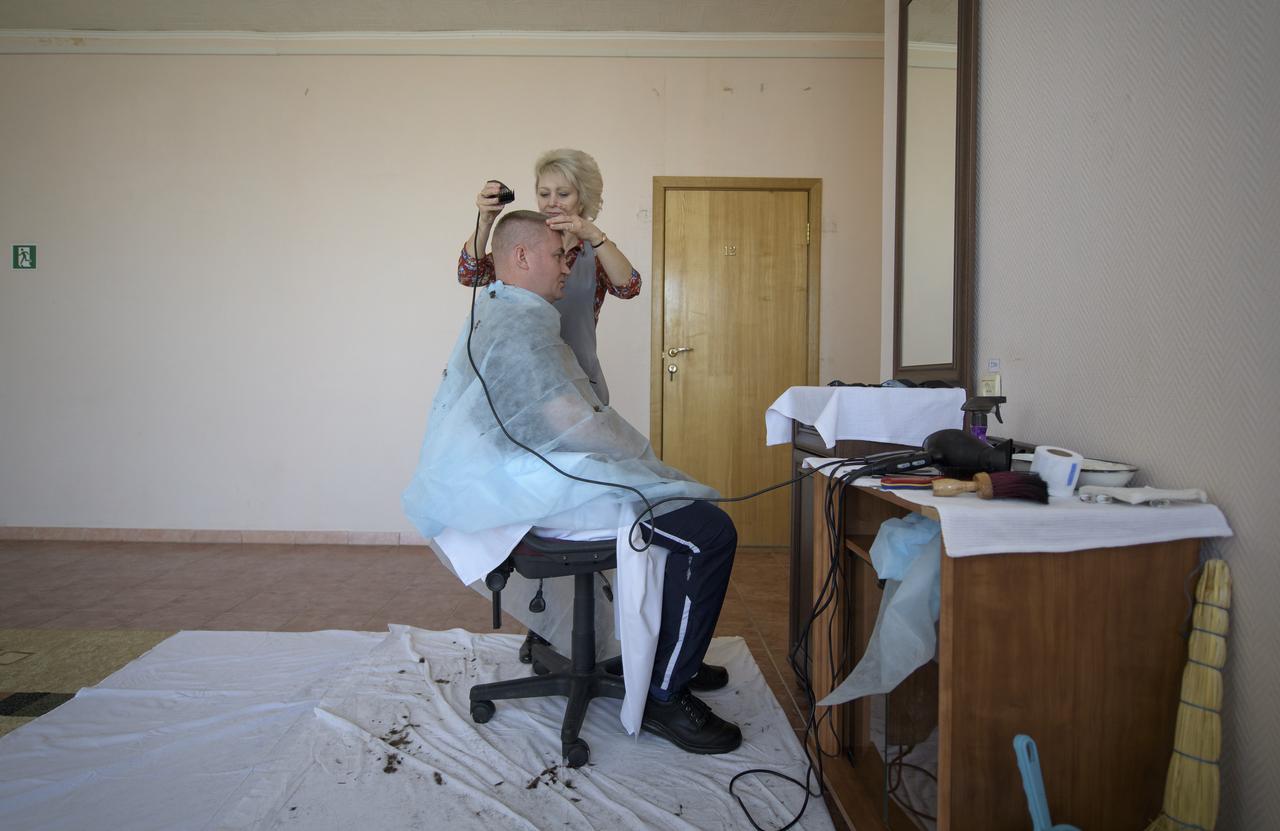 Expedition 59 cosmonaut Alexey Ovchinin of Roscosmos gets his hair cut, Tuesday, March 12, 2019 at the Cosmonaut Hotel in Baikonur, Kazakhstan. Ovchinin and fellow Expedition 59 crewmembers Nick Hague and Christina Koch of NASA will launch March 14, U.S. time, on the Soyuz MS-12 spacecraft from the Baikonur Cosmodrome for a six-and-a-half month mission on the International Space Station. Photo Credit: (NASA/Bill Ingalls)