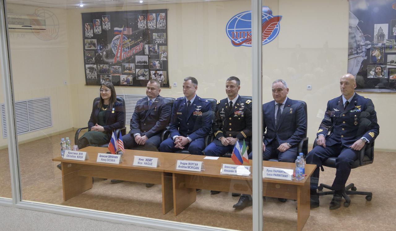 Expedition 59 crewmembers Christina Koch of NASA, left, Alexey Ovchinin of Roscosmos and Nick Hague of NASA, along with backup crewmembers Drew Morgan of NASA, Alexander Skvortsov of Roscosmos, and Luca Parmitano of the European Space Agency, right, are seen during the State Commission meeting to approve the crew's Soyuz launch to the International Space Station, Wednesday, March 13, 2019 at the Cosmonaut Hotel in Baikonur, Kazakhstan. Hague, Koch, and Ovchinin will launch March 14, U.S. time, on the Soyuz MS-12 spacecraft from the Baikonur Cosmodrome for a six-and-a-half month mission on the International Space Station. Photo Credit: (NASA/Bill Ingalls)