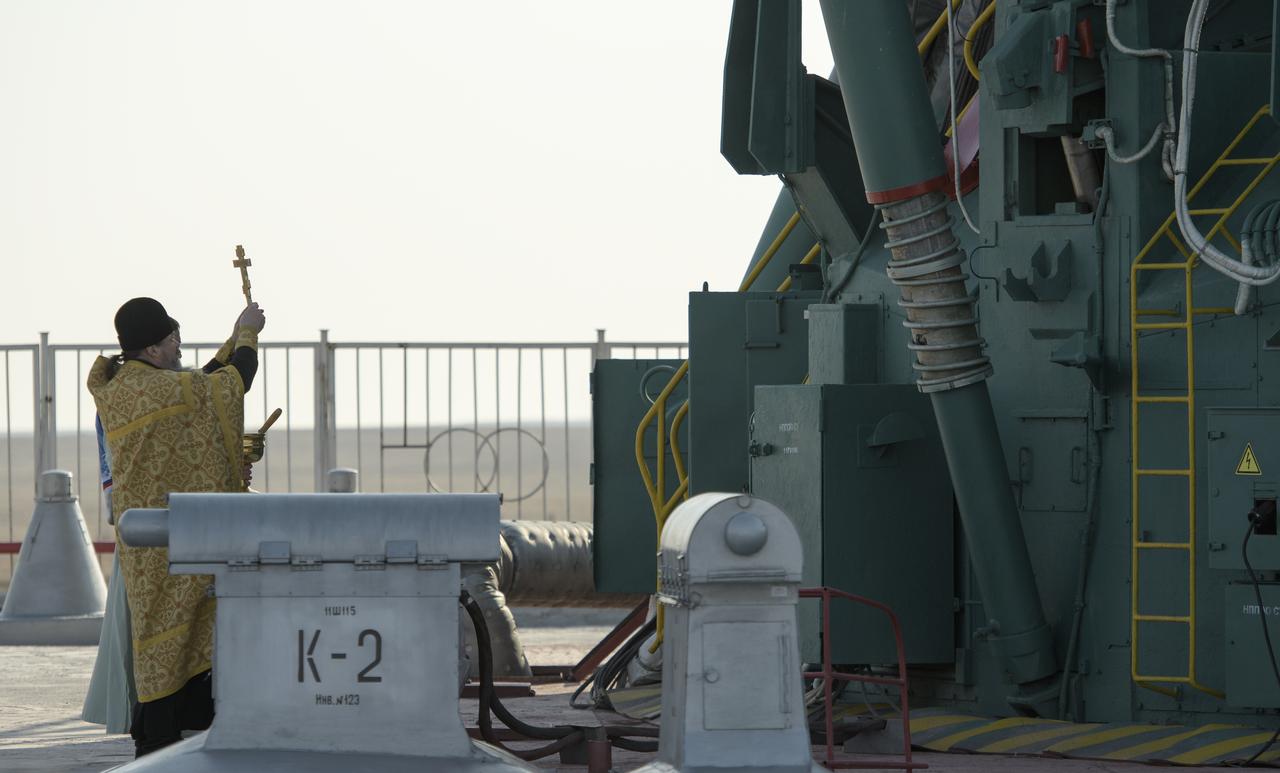 Russian Orthodox Priest Father Sergei blesses the Soyuz rocket at the Baikonur Cosmodrome launch pad, Thursday, March 14, 2019 in Baikonur, Kazakhstan. Expedition 59 astronauts Nick Hague and Christina Koch of NASA, along with Alexey Ovchinin of Roscosmos will launch later in the day, U.S. time, on the Soyuz MS-12 spacecraft from the Baikonur Cosmodrome for a six-and-a-half month mission on the International Space Station. Photo Credit: (NASA/Bill Ingalls)