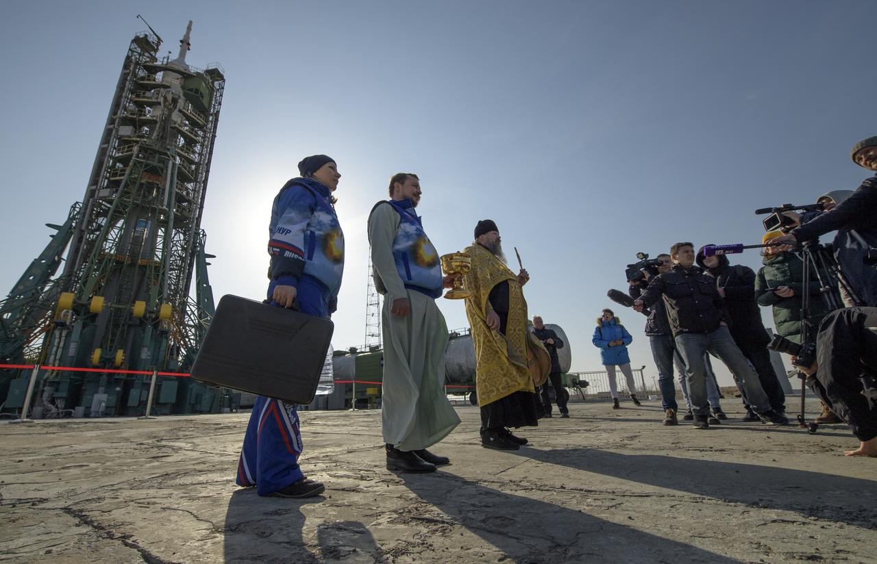 Russian Orthodox Priest Father Sergei blesses members of the media at the Baikonur Cosmodrome launch pad, Thursday, March 14, 2019 in Baikonur, Kazakhstan. Expedition 59 astronauts Nick Hague and Christina Koch of NASA, along with Alexey Ovchinin of Roscosmos will launch later in the day, U.S. time, on the Soyuz MS-12 spacecraft from the Baikonur Cosmodrome for a six-and-a-half month mission on the International Space Station. Photo Credit: (NASA/Bill Ingalls)