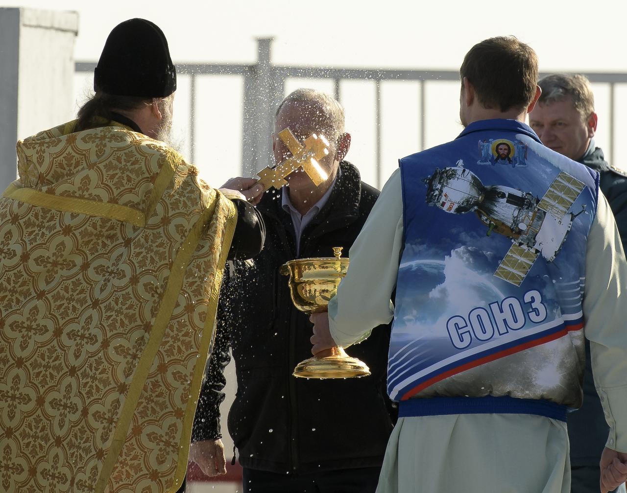 Russian Orthodox Priest Father Sergei blesses mission management at the Baikonur Cosmodrome launch pad, Thursday, March 14, 2019 in Baikonur, Kazakhstan. Expedition 59 astronauts Nick Hague and Christina Koch of NASA, along with Alexey Ovchinin of Roscosmos will launch later in the day, U.S. time, on the Soyuz MS-12 spacecraft from the Baikonur Cosmodrome for a six-and-a-half month mission on the International Space Station. Photo Credit: (NASA/Bill Ingalls)