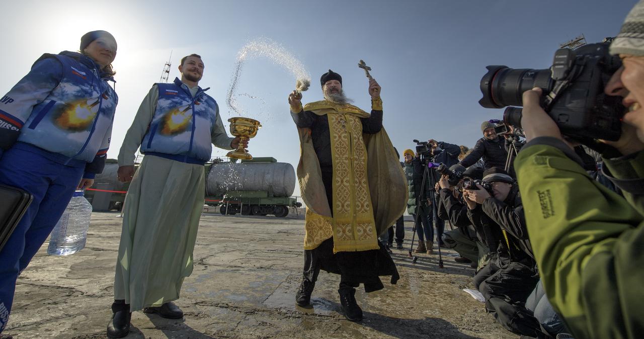 Russian Orthodox Priest Father Sergei blesses members of the media at the Baikonur Cosmodrome launch pad, Thursday, March 14, 2019 in Baikonur, Kazakhstan. Expedition 59 astronauts Nick Hague and Christina Koch of NASA, along with Alexey Ovchinin of Roscosmos will launch later in the day, U.S. time, on the Soyuz MS-12 spacecraft from the Baikonur Cosmodrome for a six-and-a-half month mission on the International Space Station. Photo Credit: (NASA/Bill Ingalls)