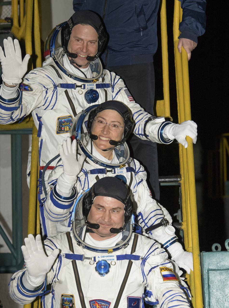 Expedition 59 crewmembers Nick Hague of NASA, top, Christina Koch of NASA, center, and Alexey Ovchinin of Roscosmos wave farewell prior to boarding the Soyuz MS-12 spacecraft for launch, Thursday, March 14, 2019 at the Baikonur Cosmodrome in Kazakhstan. Hague, Koch, and Ovchinin will spend six-and-a-half months living and working aboard the International Space Station. Photo Credit: (NASA/Bill Ingalls)