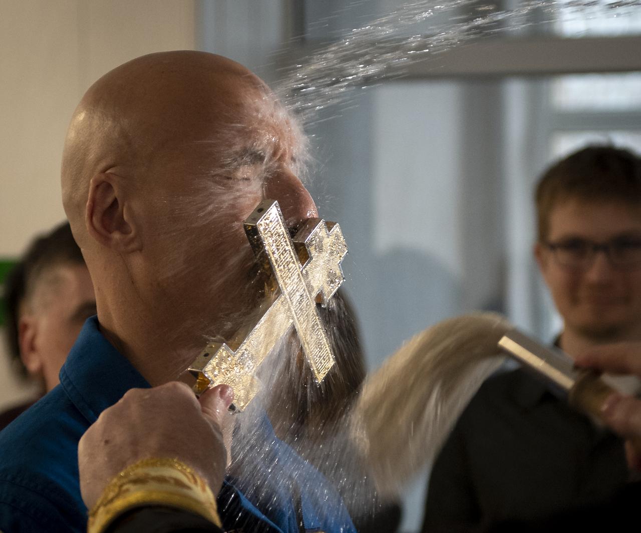 Expedition 59 backup crewmember Luca Parmitano of the European Space Agency is blessed by a Russian Orthodox Priest in the Cosmonaut Hotel prior to departing for the prime crew's launch on a Soyuz rocket, Thursday, March 14, 2019 in Baikonur, Kazakhstan. Expedition 59 crewmembers Nick Hague and Christina Koch of NASA, along with Alexey Ovchinin of Roscosmos launched March 14, U.S. time, on the Soyuz MS-12 spacecraft from the Baikonur Cosmodrome for a six-and-a-half month mission on the International Space Station. Photo Credit: (NASA/Bill Ingalls)