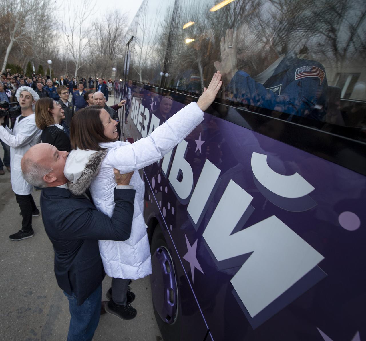 Expedition 59 astronaut Nick Hague's wife Catie Hague is lifted up by NASA astronaut Jeff Williams as she wishes farewell to husband as he and fellow crewmemebers Christina Koch and Alexey Ovchinin depart the Cosmonaut Hotel, Thursday, March 14, 2019 in Baikonur, Kazakhstan. Hague, Koch, and Ovchinin launched March 14, U.S. time, on the Soyuz MS-12 spacecraft from the Baikonur Cosmodrome for a six-and-a-half month mission on the International Space Station. Photo Credit: (NASA/Bill Ingalls)