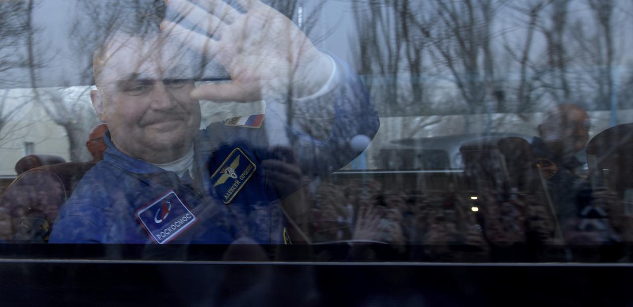 Expedition 59 cosmonaut Alexey Ovchinin of Roscosmos waves farewell to family and friends as the bus carrying him and fellow crewmembers Christina Koch and Nick Hague of NASA departs the Cosmonaut Hotel ahead of their Soyuz launch to the International Space Station, Thursday, March 14, 2019 in Baikonur, Kazakhstan. Hague, Koch, and Ovchinin will launch March 14, U.S. time, on the Soyuz MS-12 spacecraft from the Baikonur Cosmodrome for a six-and-a-half month mission on the International Space Station. Photo Credit: (NASA/Bill Ingalls)
