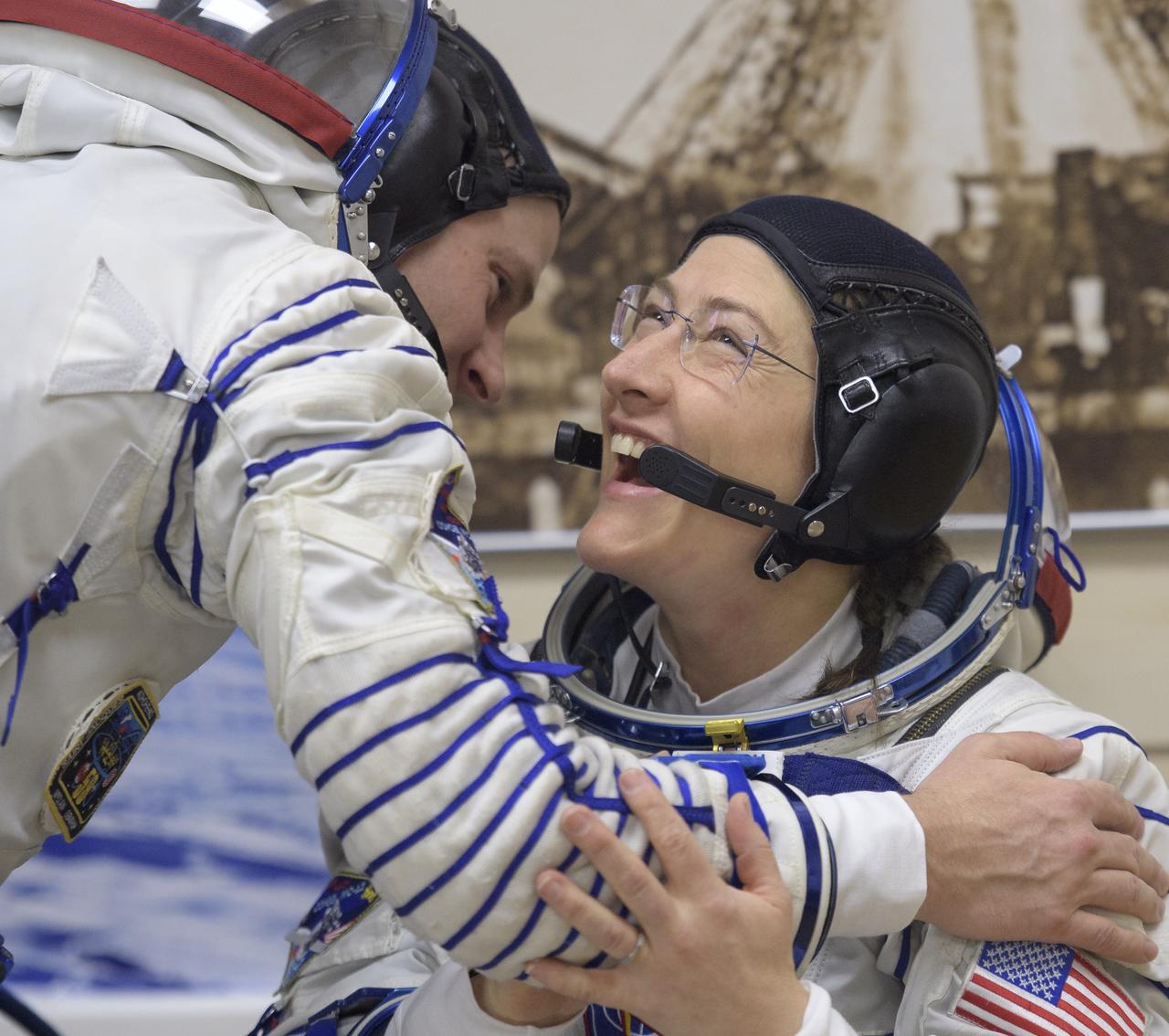 Expedition 59 astronaut Christina Koch of NASA laughs as she talks with Nick Hague while waiting to have their Sokol suits pressure checked a few hours ahead of their launch on a Soyuz rocket with Alexey Ovchinin of Roscosmos, Thursday, March 14, 2019 at the Baikonur Cosmodrome in Kazakhstan. Hague, Koch, and Ovchinin launched March 14, U.S. time, on the Soyuz MS-12 spacecraft from the Baikonur Cosmodrome for a six-and-a-half month mission on the International Space Station. Photo Credit: (NASA/Bill Ingalls)