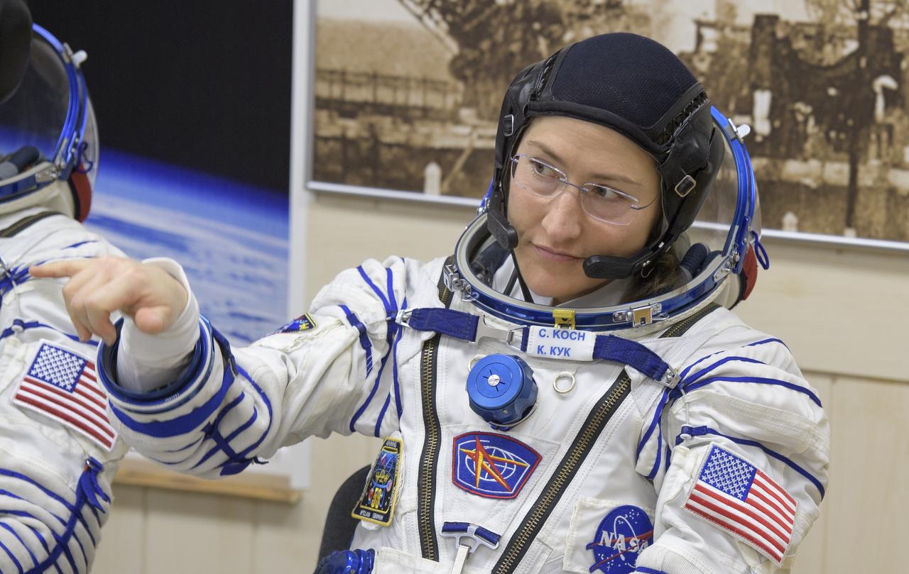 Expedition 59 astronaut Christina Koch of NASA gestures to family and friends as she waits to have her Sokol suit pressure checked ahead of her launch on a Soyuz rocket with Nick Hague of NASA and Alexey Ovchinin of Roscosmos, Thursday, March 14, 2019 at the Baikonur Cosmodrome in Kazakhstan. Hague, Koch, and Ovchinin launched March 14, U.S. time, on the Soyuz MS-12 spacecraft from the Baikonur Cosmodrome for a six-and-a-half month mission on the International Space Station. Photo Credit: (NASA/Bill Ingalls)