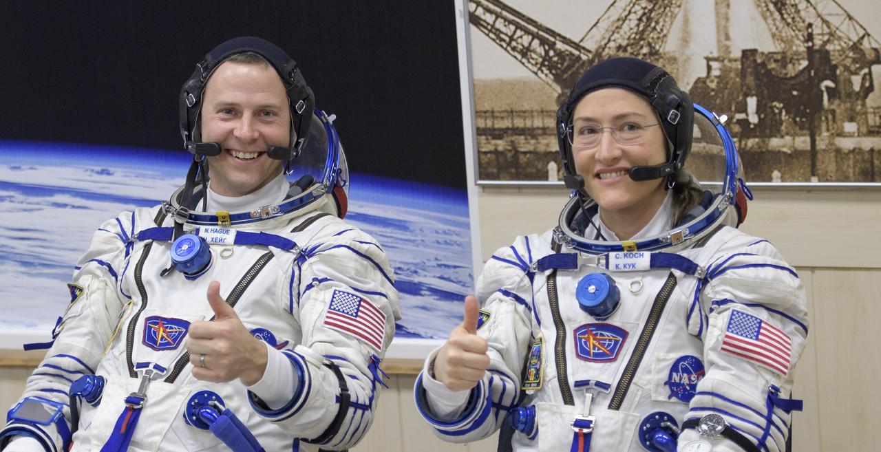 Expedition 59 astronaut Nick Hague and Christina Koch of NASA give a thumbs up while getting their Sokol suit pressure checked prior to launch on a Soyuz rocket with Alexey Ovchinin of Roscosmos, Thursday, March 14, 2019 at the Baikonur Cosmodrome in Kazakhstan. Hague, Koch, and Ovchinin launched March 14, U.S. time, on the Soyuz MS-12 spacecraft from the Baikonur Cosmodrome for a six-and-a-half month mission on the International Space Station. Photo Credit: (NASA/Bill Ingalls)