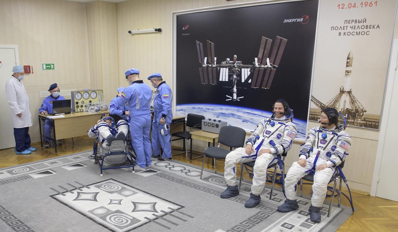 Expedition 59 cosmonaut Alexey Ovchinin of Roscosmos, reclined left, Nick Hague and Christina Koch of NASA, right, have their Sokol suits pressure checked prior to launch on a Soyuz rocket, Thursday, March 14, 2019 at the Baikonur Cosmodrome in Kazakhstan. Hague, Koch, and Ovchinin launched March 14, U.S. time, on the Soyuz MS-12 spacecraft from the Baikonur Cosmodrome for a six-and-a-half month mission on the International Space Station. Photo Credit: (NASA/Bill Ingalls)