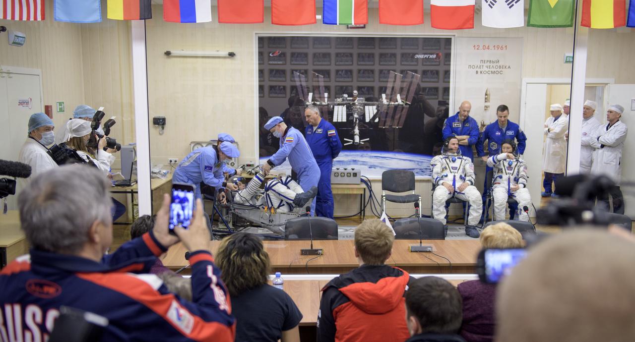 Expedition 59 cosmonaut Alexey Ovchinin of Roscosmos, reclined left, Nick Hague and Christina Koch of NASA, right, have their Sokol suits pressure checked prior to launch on a Soyuz rocket, Thursday, March 14, 2019 at the Baikonur Cosmodrome in Kazakhstan. Hague, Koch, and Ovchinin launched March 14, U.S. time, on the Soyuz MS-12 spacecraft from the Baikonur Cosmodrome for a six-and-a-half month mission on the International Space Station. Photo Credit: (NASA/Bill Ingalls)