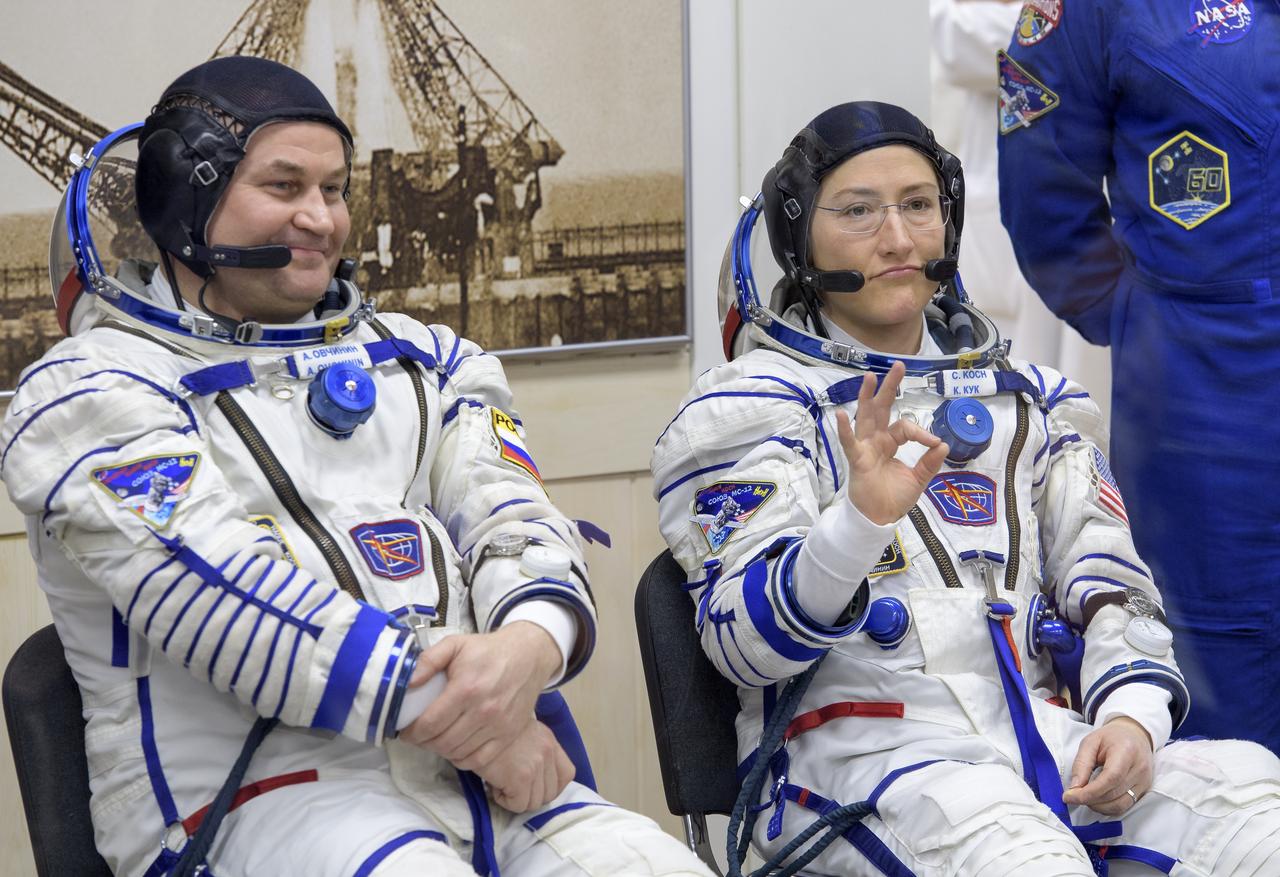Expedition 59 cosmonaut Alexey Ovchinin of Roscosmos, left, and Christina Koch of NASA smile and wave to family while getting their Sokol suit pressure checked prior to launch on a Soyuz rocket with Nick Hague of NASA, Thursday, March 14, 2019 at the Baikonur Cosmodrome in Kazakhstan. Hague, Koch, and Ovchinin launched March 14, U.S. time, on the Soyuz MS-12 spacecraft from the Baikonur Cosmodrome for a six-and-a-half month mission on the International Space Station. Photo Credit: (NASA/Bill Ingalls)