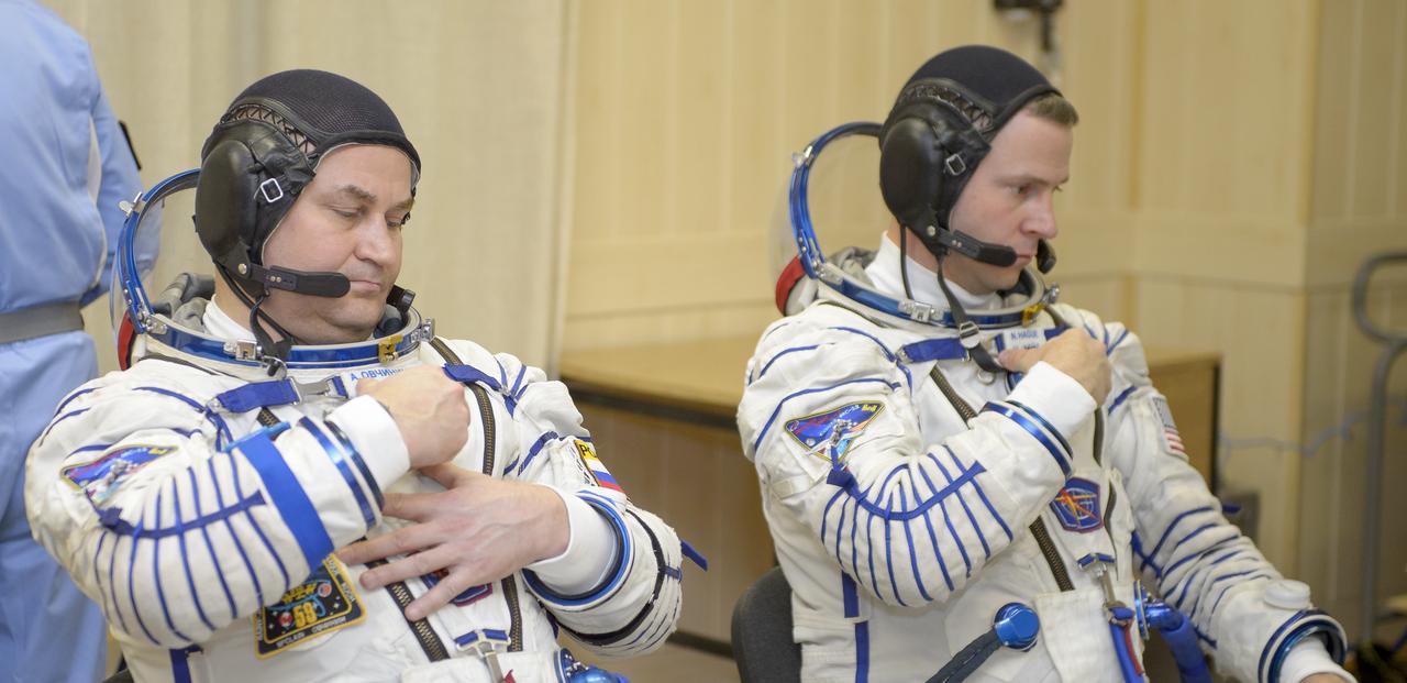 Expedition 59 cosmonaut Alexey Ovchinin of Roscosmos, left, and Nick Hague of NASA don their Sokol suits prior to their launch on a Soyuz rocket with Christina Koch of NASA, Thursday, March 14, 2019 at the Baikonur Cosmodrome in Kazakhstan. Hague, Koch, and Ovchinin launched March 14, U.S. time, on the Soyuz MS-12 spacecraft from the Baikonur Cosmodrome for a six-and-a-half month mission on the International Space Station Photo Credit: (NASA/GCTC/Irina Spector)