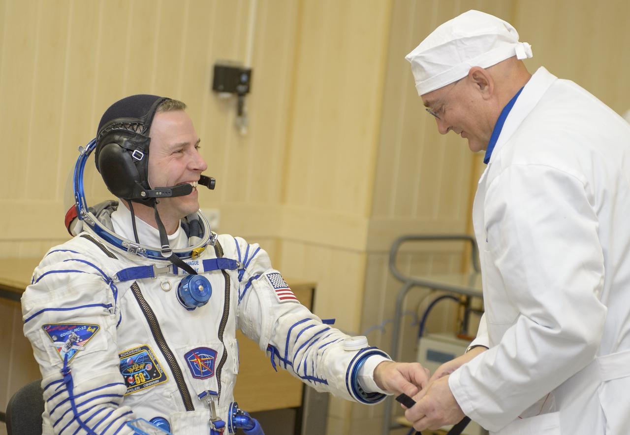 Expedition 59 astronaut Nick Hague of NASA laughs as he talks with NASA Flight Surgeon Blake Chamberlain prior to his launch on a Soyuz rocket with Christina Koch of NASA and Alexey Ovchinin of Roscosmos, Thursday, March 14, 2019 at the Baikonur Cosmodrome in Kazakhstan. Hague, Koch, and Ovchinin launched March 14, U.S. time, on the Soyuz MS-12 spacecraft from the Baikonur Cosmodrome for a six-and-a-half month mission on the International Space Station Photo Credit: (NASA/GCTC/Irina Spector)