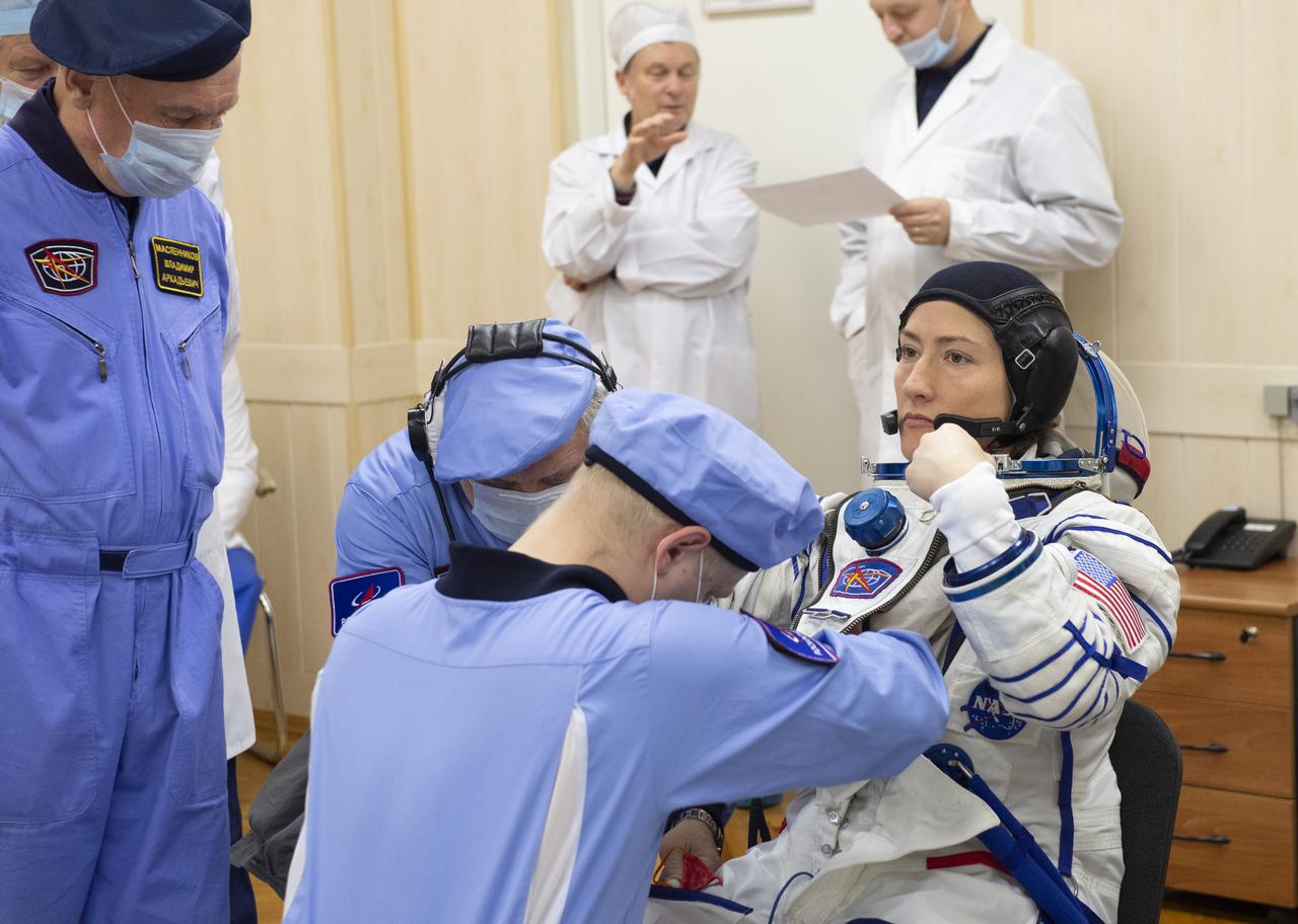 Expedition 59 astronaut Christina Koch of NASA dons her Sokol suit prior to her launch on a Soyuz rocket with Nick Hague of NASA and Alexey Ovchinin of Roscosmos, Thursday, March 14, 2019 at the Baikonur Cosmodrome in Kazakhstan. Hague, Koch, and Ovchinin launched March 14, U.S. time, on the Soyuz MS-12 spacecraft from the Baikonur Cosmodrome for a six-and-a-half month mission on the International Space Station Photo Credit: (NASA/GCTC/Irina Spector)