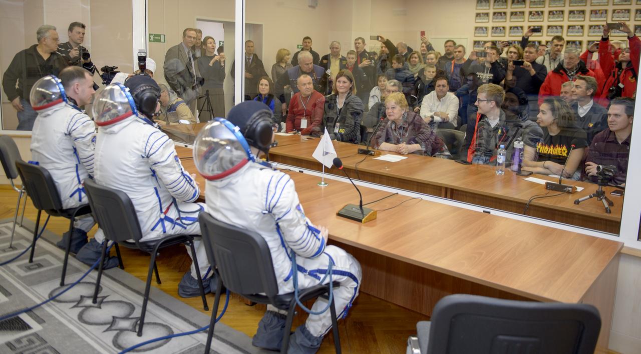Expedition 59 crewmembers Christina Koch of NASA, Alexey Ovchinin of Roscosmos and Nick Hague of NASA, talk with family and mission management prior to their launch, Thursday, March 14, 2019 at the Baikonur Cosmodrome in Kazakhstan. Hague, Koch, and Ovchinin launched March 14, U.S. time, on the Soyuz MS-12 spacecraft from the Baikonur Cosmodrome for a six-and-a-half month mission on the International Space Station. Photo Credit: (NASA/GCTC/Irina Spector)