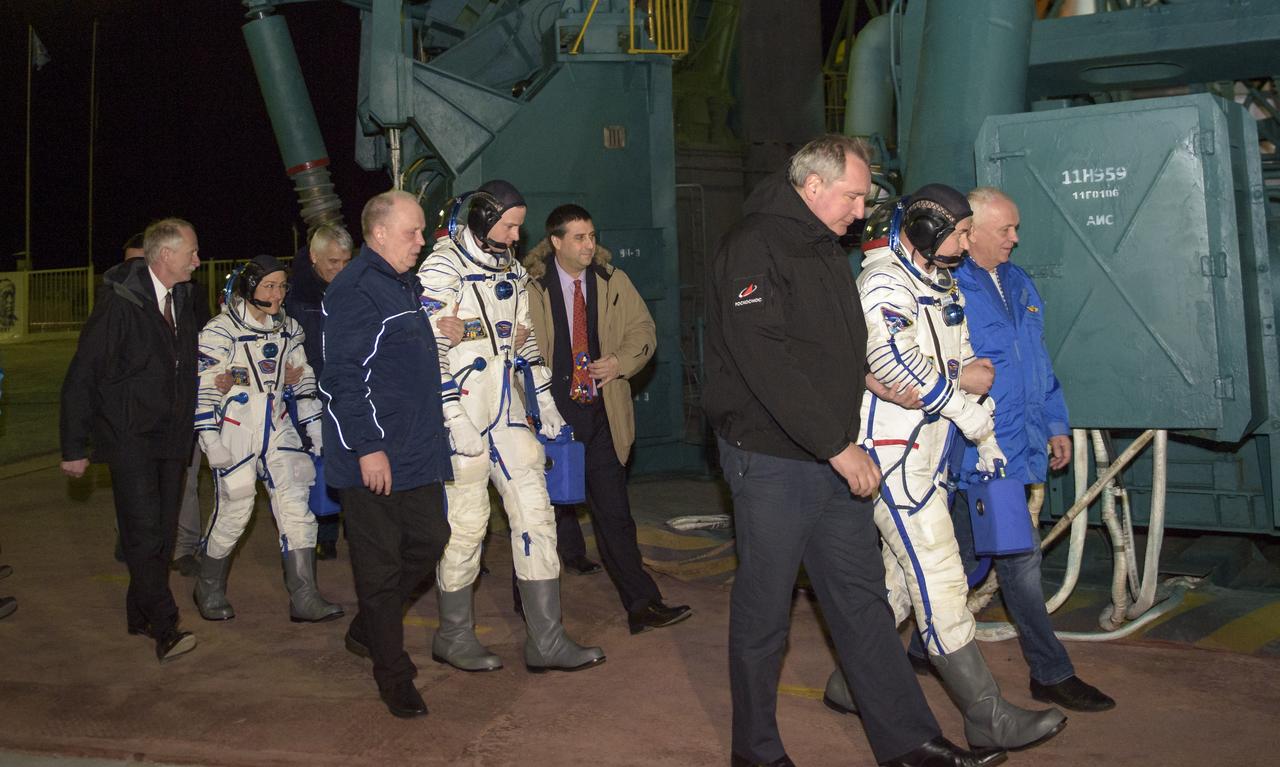 Expedition 59 crewmembers Christina Koch of NASA, left, Nick Hague of NASA, and Alexey Ovchinin of Roscosmos, right, walk to board the Soyuz rocket for launch, Thursday, March 14, 2019 at the Baikonur Cosmodrome in Kazakhstan. Hague, Koch, and Ovchinin launched March 14, U.S. time, on the Soyuz MS-12 spacecraft from the Baikonur Cosmodrome for a six-and-a-half month mission on the International Space Station. Photo Credit: (NASA/GCTC/Irina Spector)
