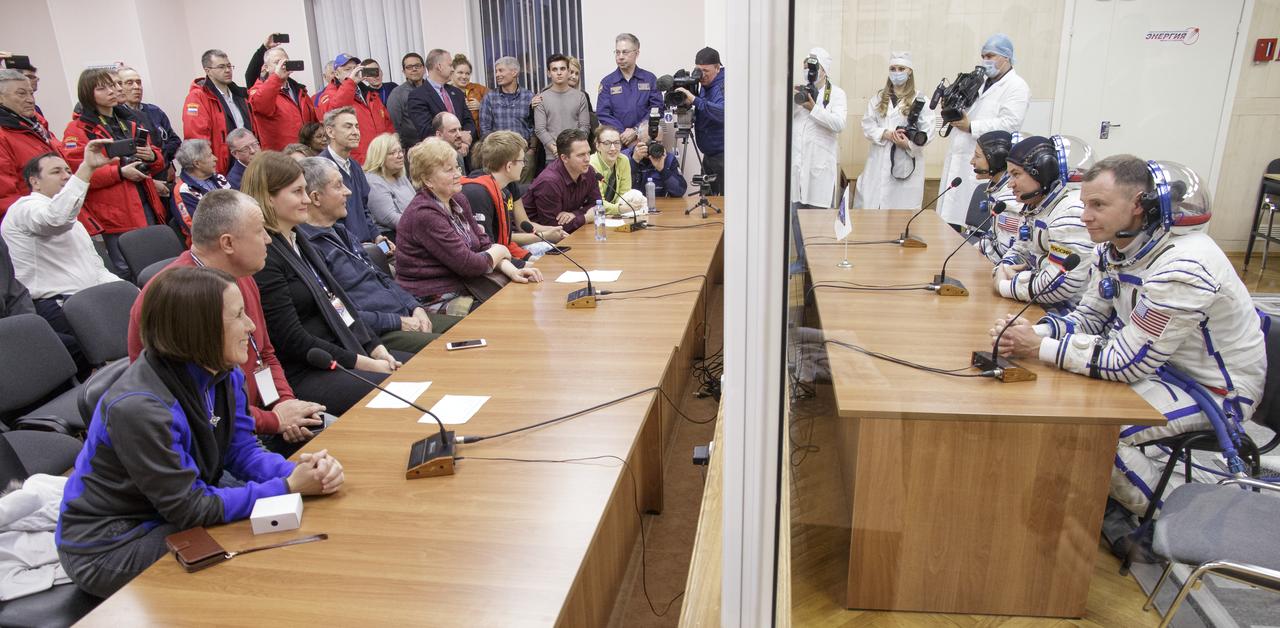 Expedition 59 crewmembers Christina Koch of NASA, Alexey Ovchinin of Roscosmos and Nick Hague of NASA, talk with family and mission management prior to their launch, Thursday, March 14, 2019 at the Baikonur Cosmodrome in Kazakhstan. Hague, Koch, and Ovchinin launched March 14, U.S. time, on the Soyuz MS-12 spacecraft from the Baikonur Cosmodrome for a six-and-a-half month mission on the International Space Station. Photo Credit: (NASA/Victor Zelentsov)