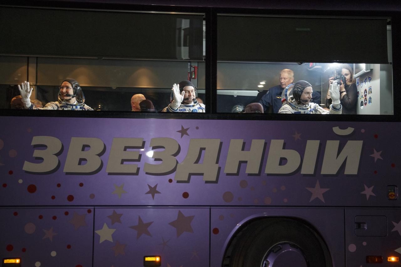 Expedition 59 astronaut Christina Koch of NASA, left, Alexey Ovchinin of Roscosmos, and Nick Hague of NASA, right, wave farewell to family and friends as they head to the launch pad, Thursday, March 14, 2019 at the Baikonur Cosmodrome in Kazakhstan. Hague, Koch, and Ovchinin launched March 14, U.S. time, on the Soyuz MS-12 spacecraft from the Baikonur Cosmodrome for a six-and-a-half month mission on the International Space Station. Photo Credit: (NASA/Victor Zelentsov)