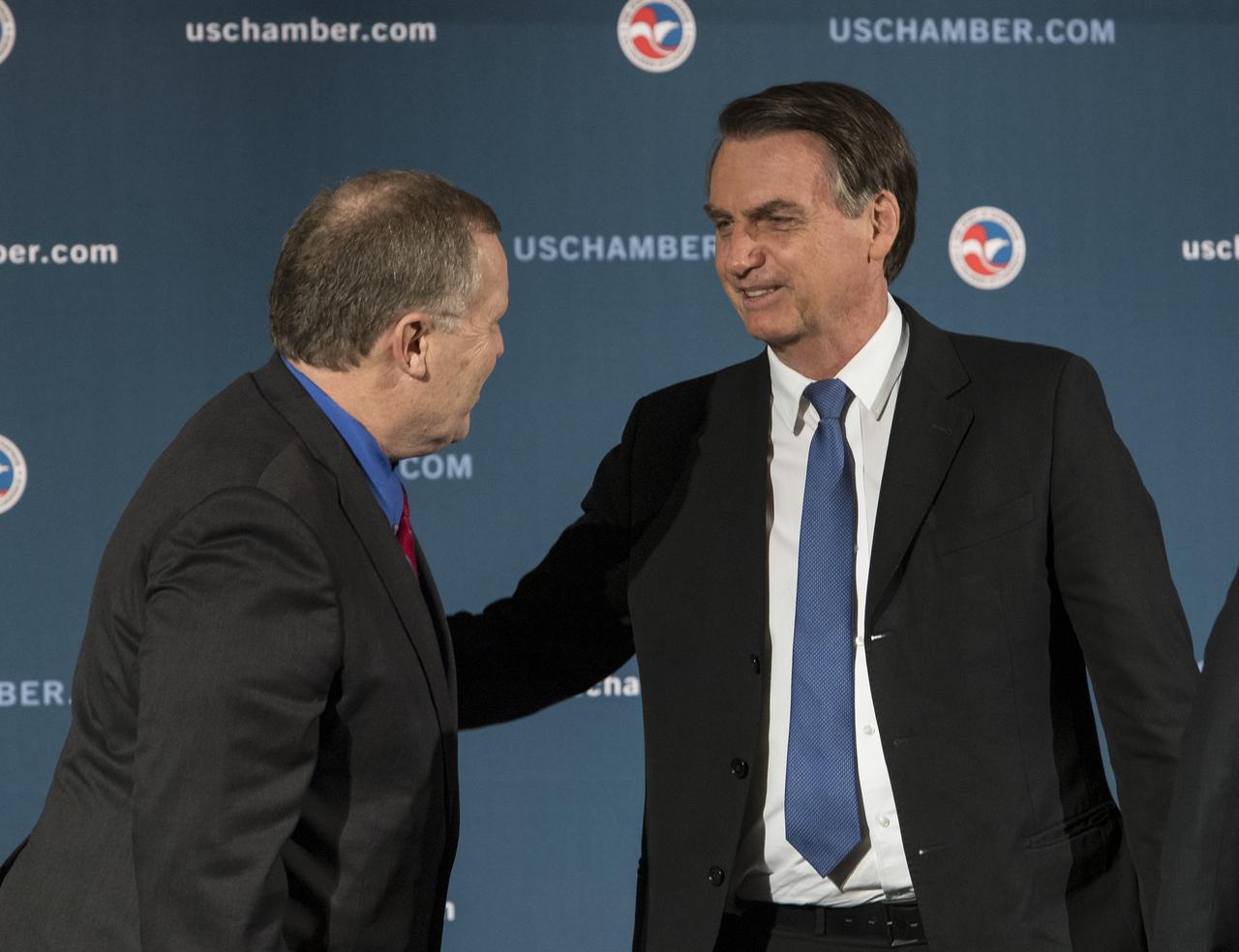 NASA Deputy Administrator James Morhard, left, speaks with H.E. President Jair Bolsonaro of Brazil, just before signing an agreement with President of the Brazilian Space Agency (AEB), Carlos Augusto Teixeira de Moura, for cooperation on the Scintillation Prediction Observations Research Task (SPORT), an upcoming NASA-AEB heliophysics CubeSat partnership, Monday, March 18, 2019, at the U.S. Chamber of Commerce in Washington. The SPORT CubeSat will investigate two ionospheric phenomena, equatorial plasma bubbles and scintillation, that disrupt radio communication systems, satellite technologies, and Global Positioning System (GPS) signals.  SPORT is currently projected to launch in the 2020 timeframe. Photo Credit: (NASA/ Aubrey Gemignani)