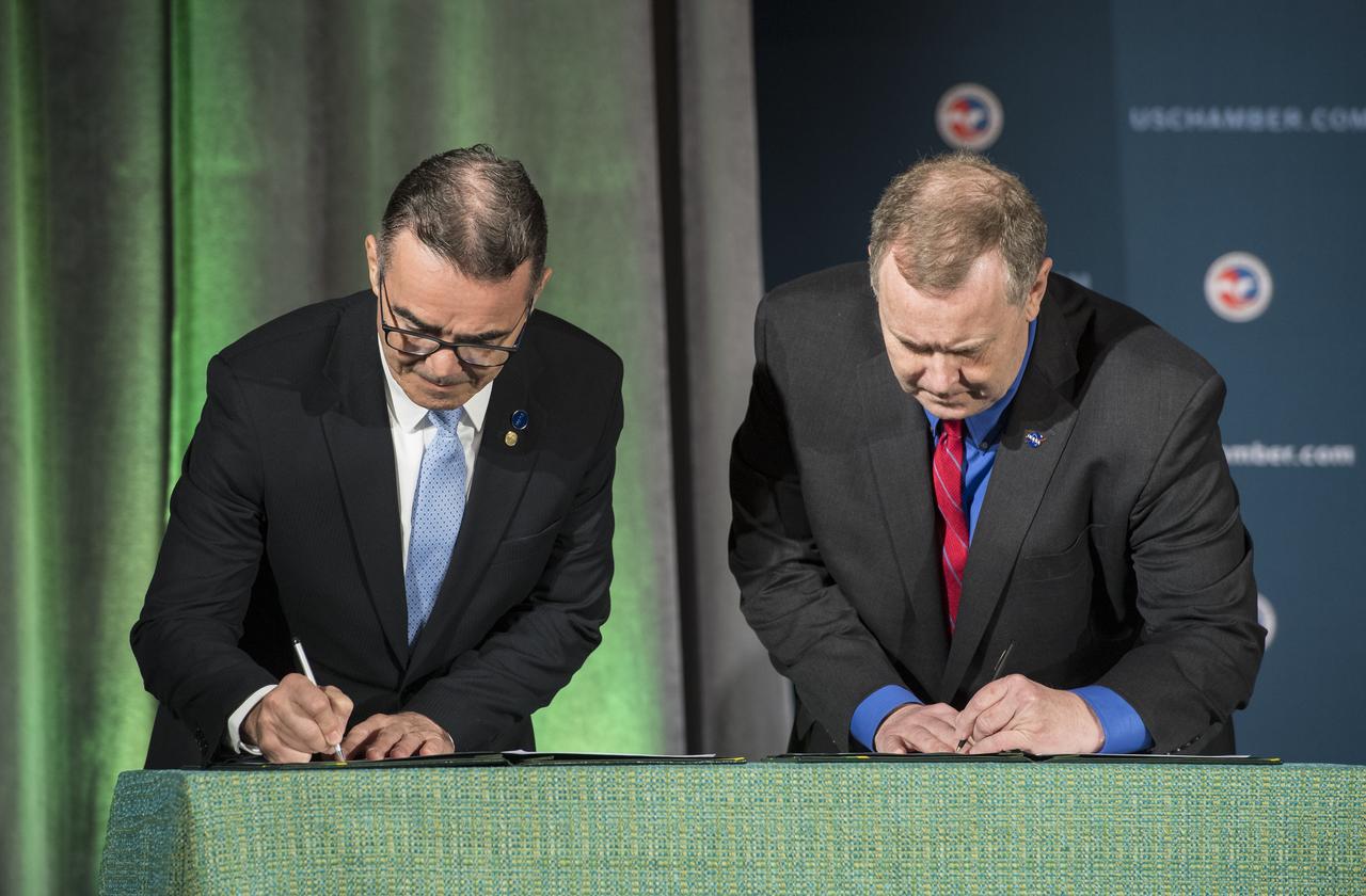 NASA Deputy Administrator James Morhard, right, and President of the Brazilian Space Agency (AEB) Carlos Augusto Teixeira de Moura, left, sign an agreement for cooperation on the Scintillation Prediction Observations Research Task (SPORT), an upcoming NASA-AEB heliophysics CubeSat partnership, Monday, March 18, 2019, at the U.S. Chamber of Commerce in Washington. The SPORT CubeSat will investigate two ionospheric phenomena, equatorial plasma bubbles and scintillation, that disrupt radio communication systems, satellite technologies, and Global Positioning System (GPS) signals.  SPORT is currently projected to launch in the 2020 timeframe. Photo Credit: (NASA/ Aubrey Gemignani)