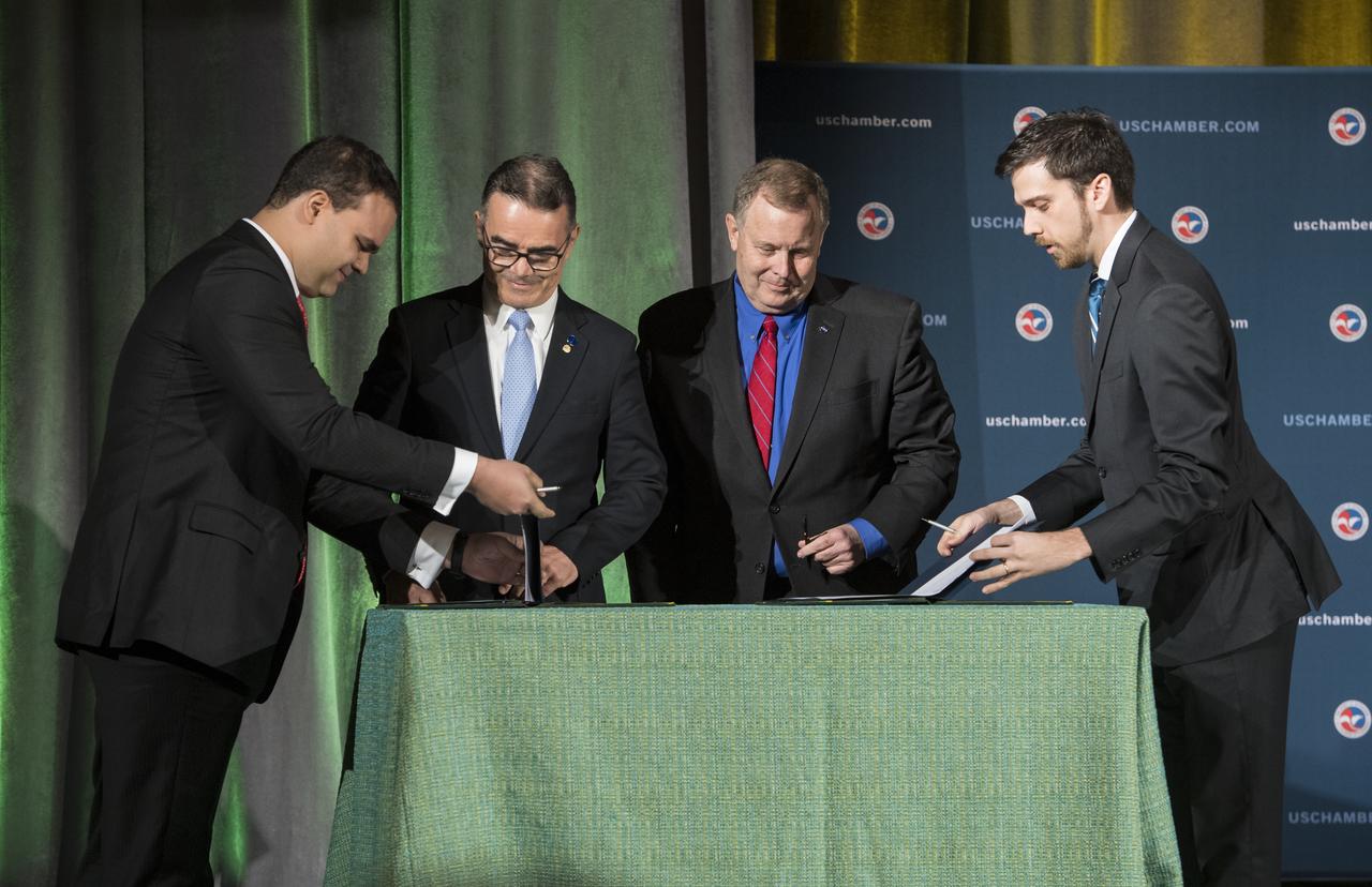 NASA Deputy Administrator James Morhard, center right, and President of the Brazilian Space Agency (AEB) Carlos Augusto Teixeira de Moura, center left, prepare to sign an agreement for cooperation on the Scintillation Prediction Observations Research Task (SPORT), an upcoming NASA-AEB heliophysics CubeSat partnership, Monday, March 18, 2019, at the U.S. Chamber of Commerce in Washington. The SPORT CubeSat will investigate two ionospheric phenomena, equatorial plasma bubbles and scintillation, that disrupt radio communication systems, satellite technologies, and Global Positioning System (GPS) signals.  SPORT is currently projected to launch in the 2020 timeframe. Photo Credit: (NASA/ Aubrey Gemignani)