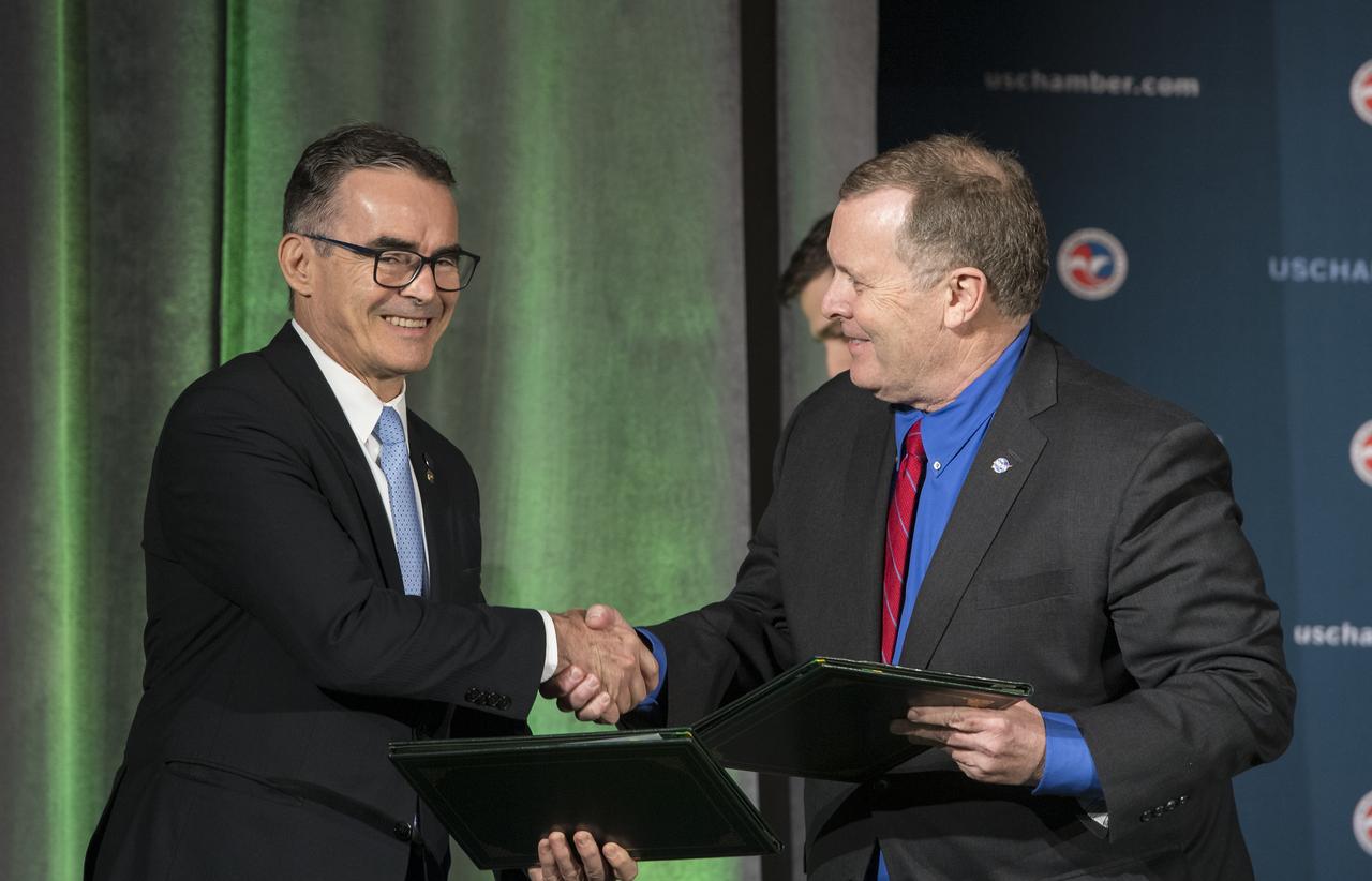 NASA Deputy Administrator James Morhard, right, shakes hands with President of the Brazilian Space Agency (AEB) Carlos Augusto Teixeira de Moura, left, after signing an agreement for cooperation on the Scintillation Prediction Observations Research Task (SPORT), an upcoming NASA-AEB heliophysics CubeSat partnership, Monday, March 18, 2019, at the U.S. Chamber of Commerce in Washington. The SPORT CubeSat will investigate two ionospheric phenomena, equatorial plasma bubbles and scintillation, that disrupt radio communication systems, satellite technologies, and Global Positioning System (GPS) signals.  SPORT is currently projected to launch in the 2020 timeframe. Photo Credit: (NASA/ Aubrey Gemignani)