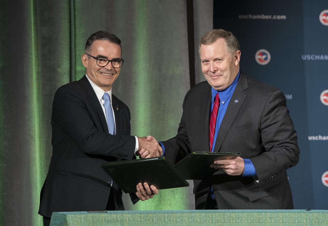 NASA Deputy Administrator James Morhard, right, shakes hands with President of the Brazilian Space Agency (AEB) Carlos Augusto Teixeira de Moura, left, after signing an agreement for cooperation on the Scintillation Prediction Observations Research Task (SPORT), an upcoming NASA-AEB heliophysics CubeSat partnership, Monday, March 18, 2019, at the U.S. Chamber of Commerce in Washington. The SPORT CubeSat will investigate two ionospheric phenomena, equatorial plasma bubbles and scintillation, that disrupt radio communication systems, satellite technologies, and Global Positioning System (GPS) signals.  SPORT is currently projected to launch in the 2020 timeframe. Photo Credit: (NASA/ Aubrey Gemignani)