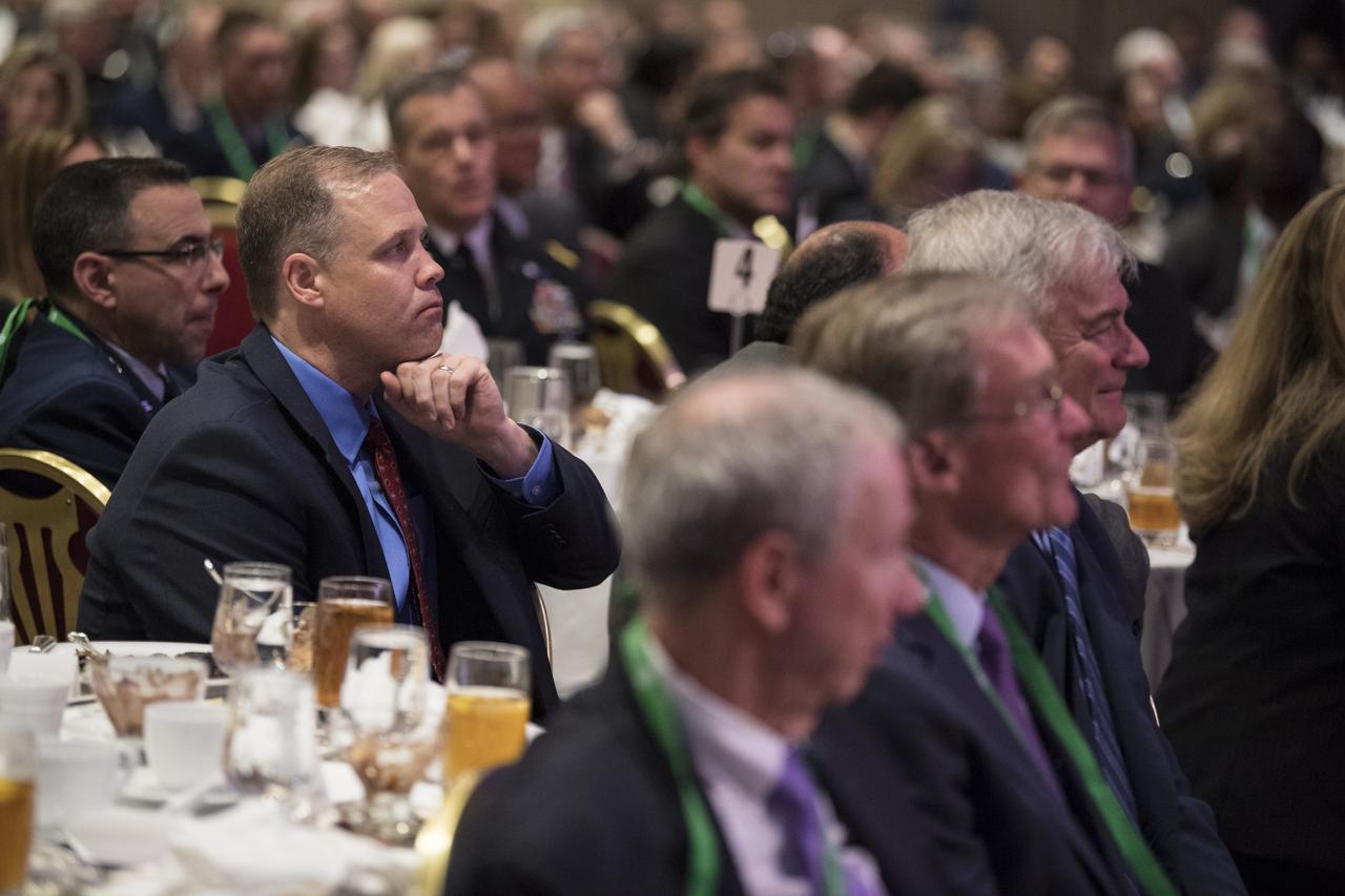 NASA Administrator Jim Bridenstine listens as General Thomas Patten Stafford, former NASA astronaut, Air Force officer and test pilot speaks at an event where he received the General James E. Hill Lifetime Achievement Award, at the Space Symposium, Tuesday, April 9, 2019, at Broadmoor Hall in Colorado Springs, Colorado. Former and current NASA Administrators were in attendance. Photo credit: (NASA/Aubrey Gemignani)