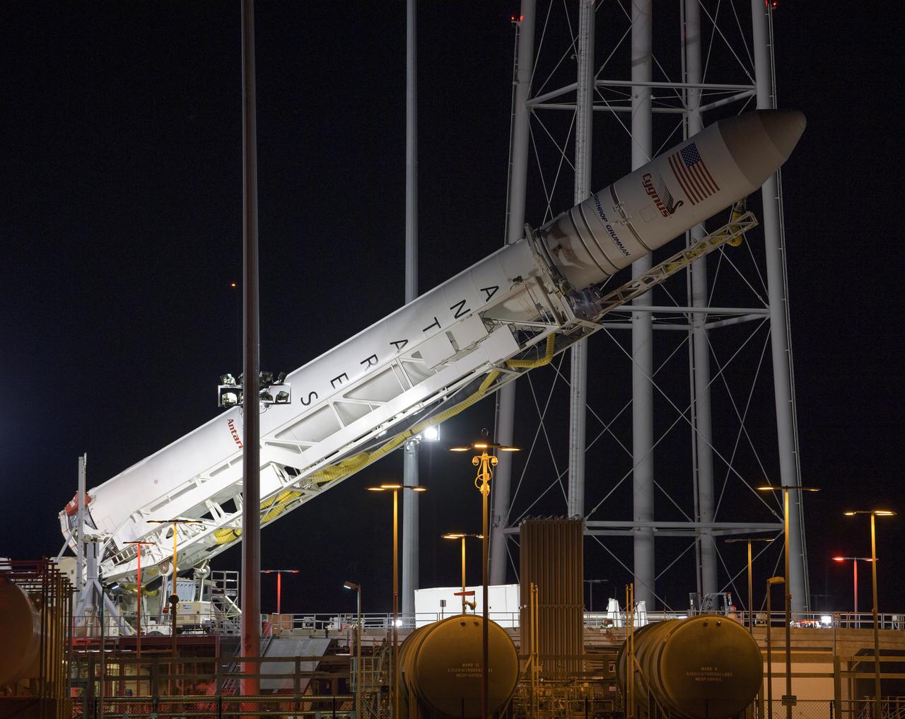 A Northrop Grumman Antares rocket carrying a Cygnus resupply spacecraft is raised into a vertical position on Pad-0A, Monday, April 15, 2019. Northrop Grumman’s 11th contracted cargo resupply mission with NASA to the International Space Station will deliver about 7,600 pounds of science and research, crew supplies and vehicle hardware to the orbital laboratory and its crew. Photo Credit: (NASA/Bill Ingalls)