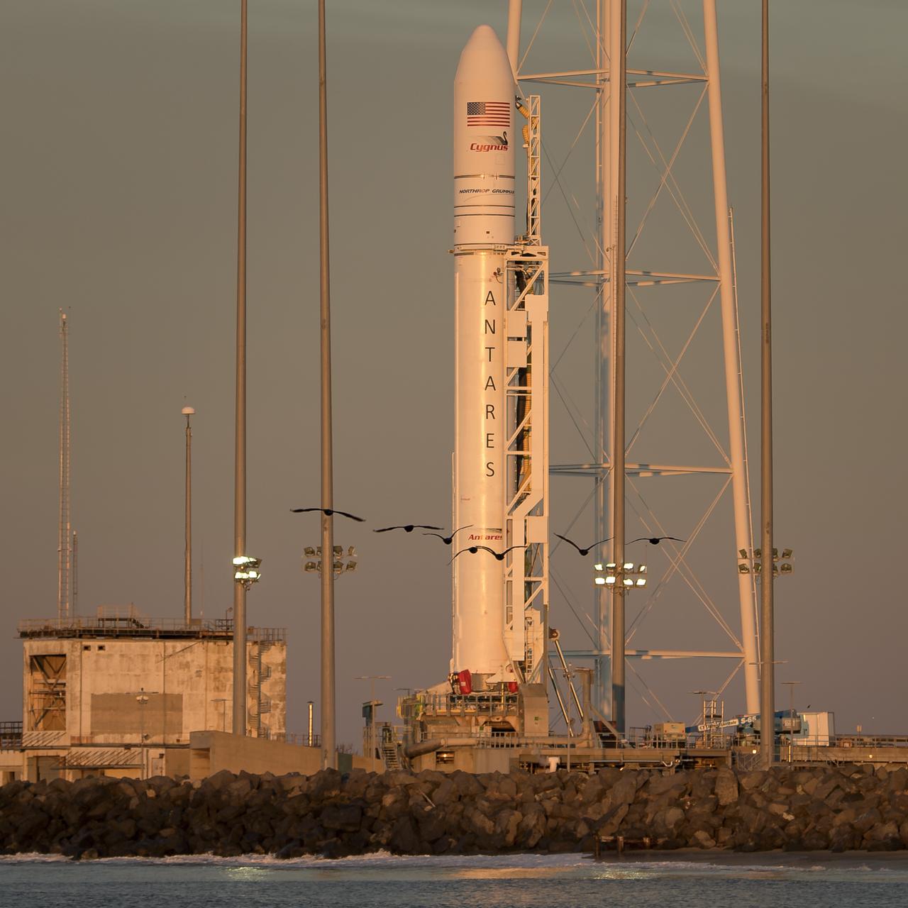 A Northrop Grumman Antares rocket carrying a Cygnus resupply spacecraft is seen during sunrise on Pad-0A, Tuesday, April 16, 2019 at NASA's Wallops Flight Facility in Virginia. Northrop Grumman’s 11th contracted cargo resupply mission with NASA to the International Space Station will deliver about 7,600 pounds of science and research, crew supplies and vehicle hardware to the orbital laboratory and its crew. Photo Credit: (NASA/Bill Ingalls)
