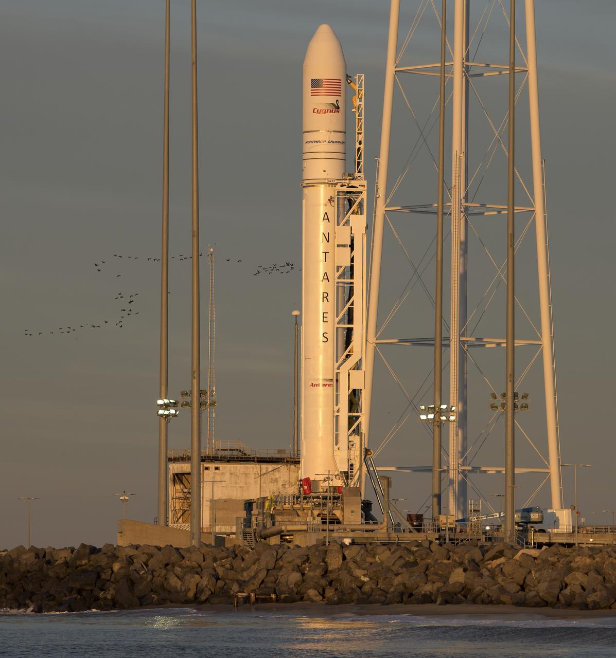 A Northrop Grumman Antares rocket carrying a Cygnus resupply spacecraft is seen during sunrise on Pad-0A, Tuesday, April 16, 2019 at NASA's Wallops Flight Facility in Virginia. Northrop Grumman’s 11th contracted cargo resupply mission with NASA to the International Space Station will deliver about 7,600 pounds of science and research, crew supplies and vehicle hardware to the orbital laboratory and its crew. Photo Credit: (NASA/Bill Ingalls)