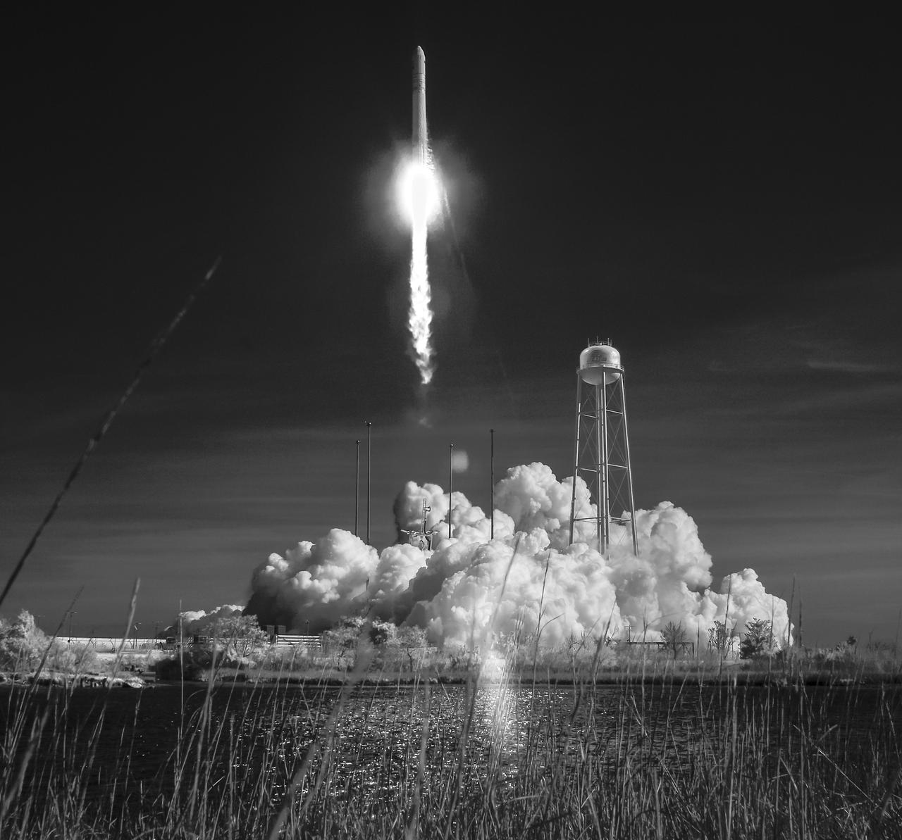 The Northrop Grumman Antares rocket, with Cygnus resupply spacecraft onboard, is seen in this black and white infrared photograph as it launches from Pad-0A, Wednesday, April 17, 2019 at NASA's Wallops Flight Facility in Virginia. Northrop Grumman's 11th contracted cargo resupply mission for NASA to the International Space Station will deliver about 7,600 pounds of science and research, crew supplies and vehicle hardware to the orbital laboratory and its crew. Photo Credit: (NASA/Bill Ingalls)