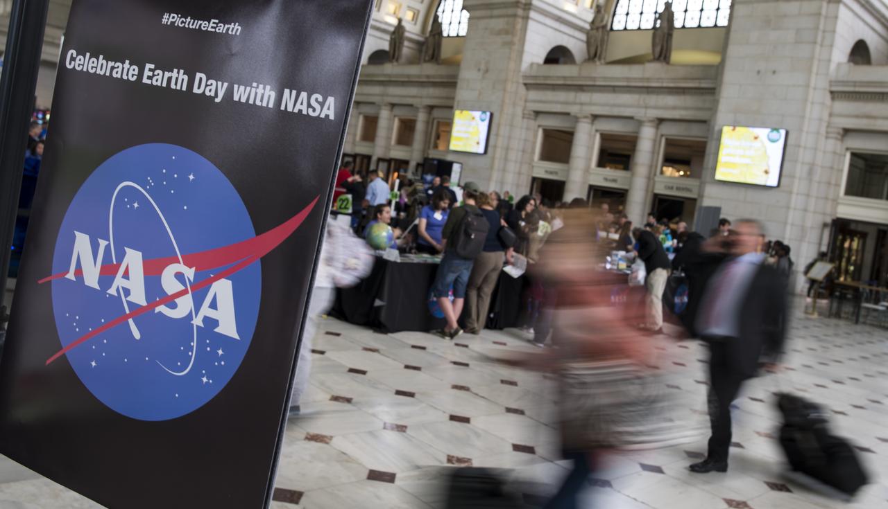Travelers walk past NASA's exhibits at the Earth Day event held at Union Station on Monday, April 22, 2019, Washington, D.C. Photo Credit: (NASA/Joel Kowsky)