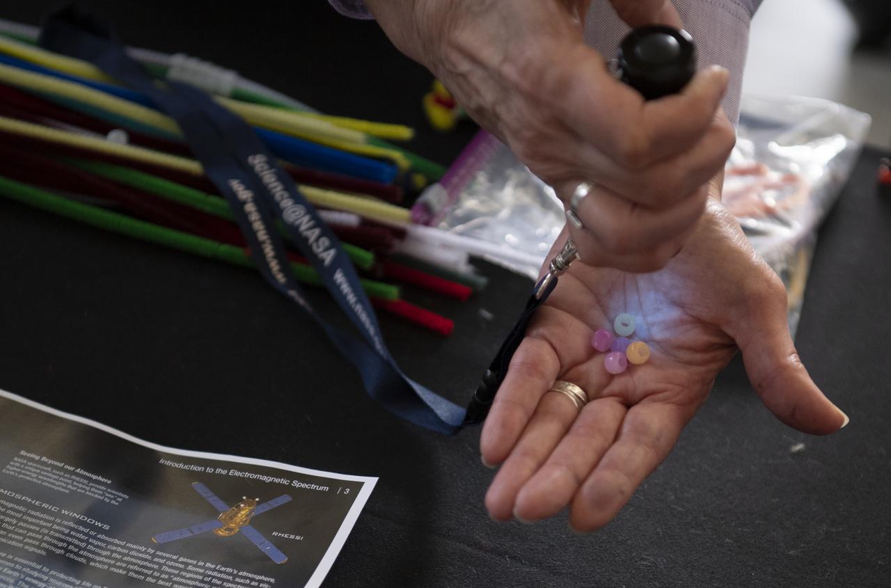 Beads treated to react to ultraviolet light are used to show how the Sun's invisible rays can effect us at one of NASA's exhibits at the Earth Day event on Monday, April 22, 2019, at Union Station in Washington, D.C. Photo Credit: (NASA/Joel Kowsky)